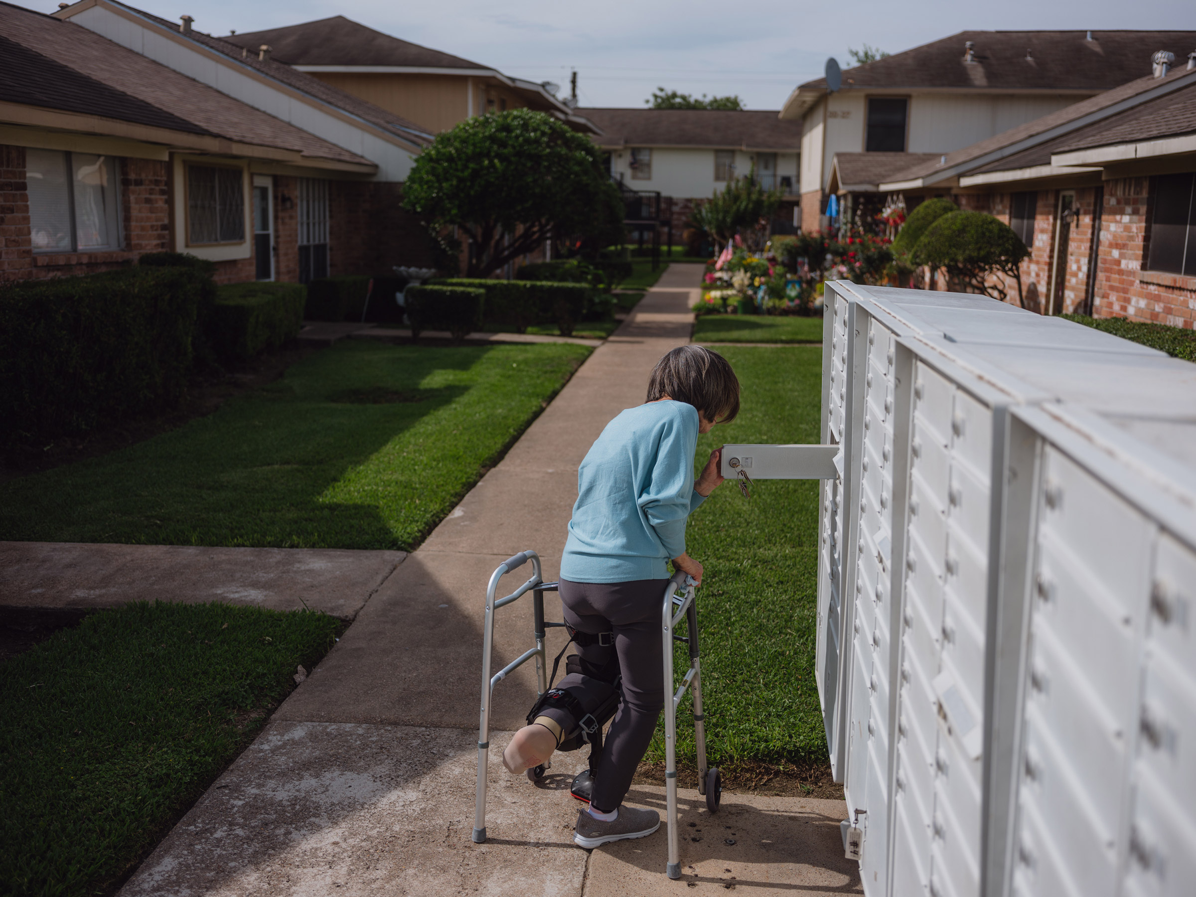 Pasadena, Texas - June 1, 2021:Nancy Thompson, 72, was seen walking to check her mail from her home in Pasadena, Texas on June 1, 2021. Thompson, an elderly person recovering from a surgical procedure and a victim of repeated falls, received assistance from CAPABLE where they retrofitted her home and provided tools to help her live more independently. Photo: Christopher Lee for TIME