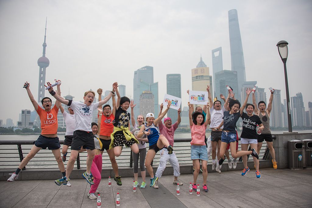 Participants of the ShanghaiPRIDE run pose for pictures during a break on the Bund in front of the financial district of Pudong in Shanghai on June 13, 2015. (JOHANNES EISELE/AFP via Getty Images)