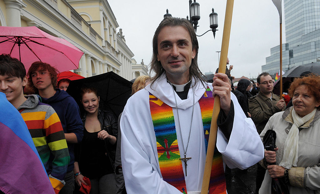 A man dressed as a priest particpates in