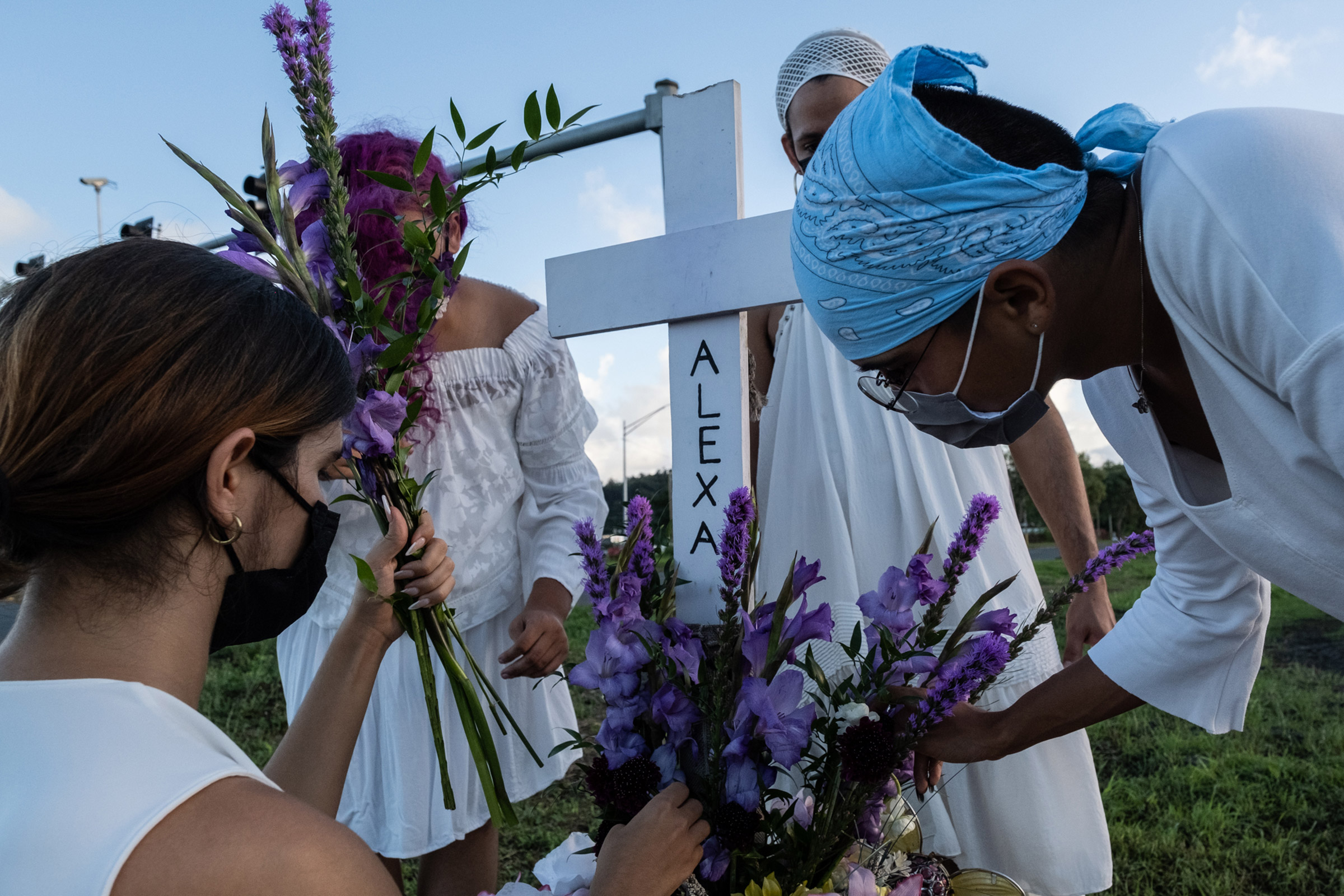 Members of House of Grace pay respects to Alexa Negrón Luciano, a transgender woman who was murdered in February 2020, on the site of a makeshift grave dedicated to her in Toa Baja, Puerto Rico. (Gabriella N. Báez—Magnum Foundation)