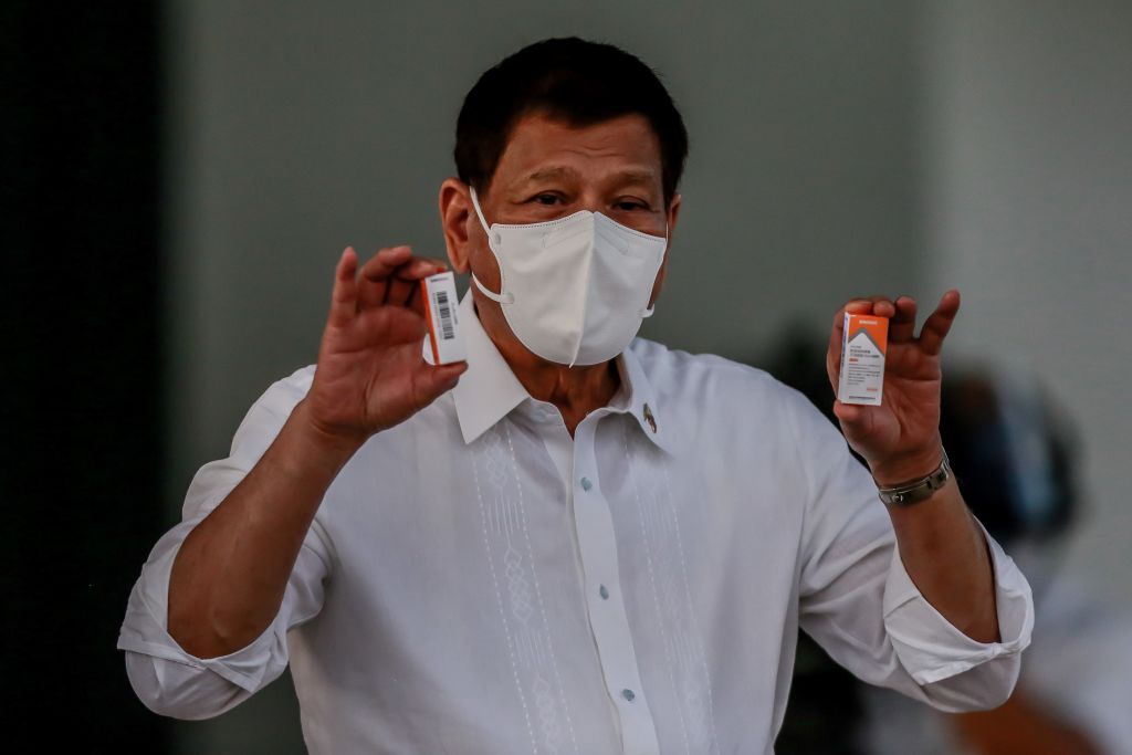 Philippine President Rodrigo Duterte shows boxes of Sinovac COVID-19 vaccines in Manila, the Philippines on March 29, 2021.
                        The Philippines on Monday received the first batch of the Sinovac COVID-19 vaccines its government has purchased from China. (Rouelle Umali–Xinhua/Getty Images)