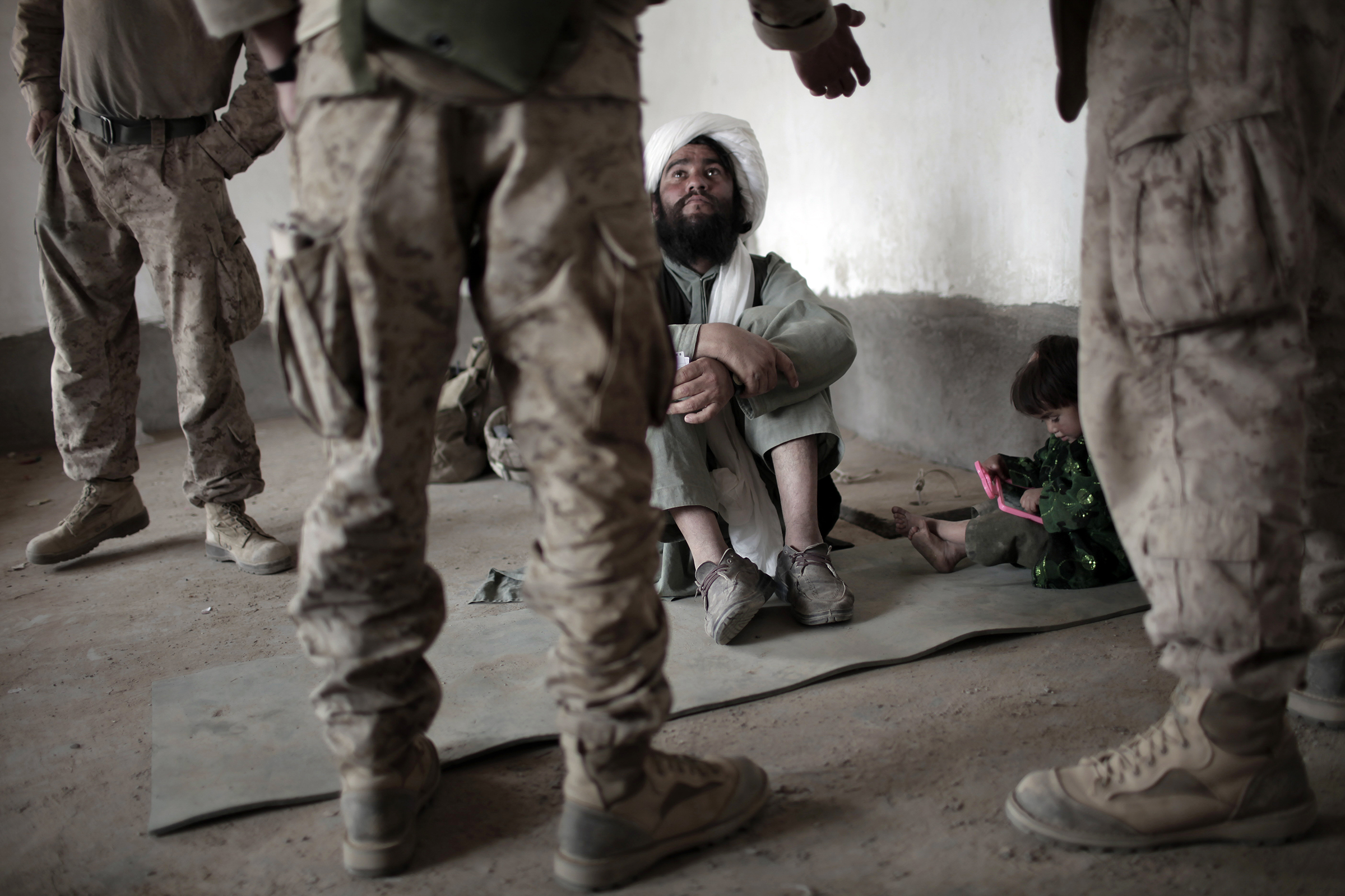 An imam listens to an interpreter for U.S. forces in Marjah, southern Afghanistan, in 2010.
