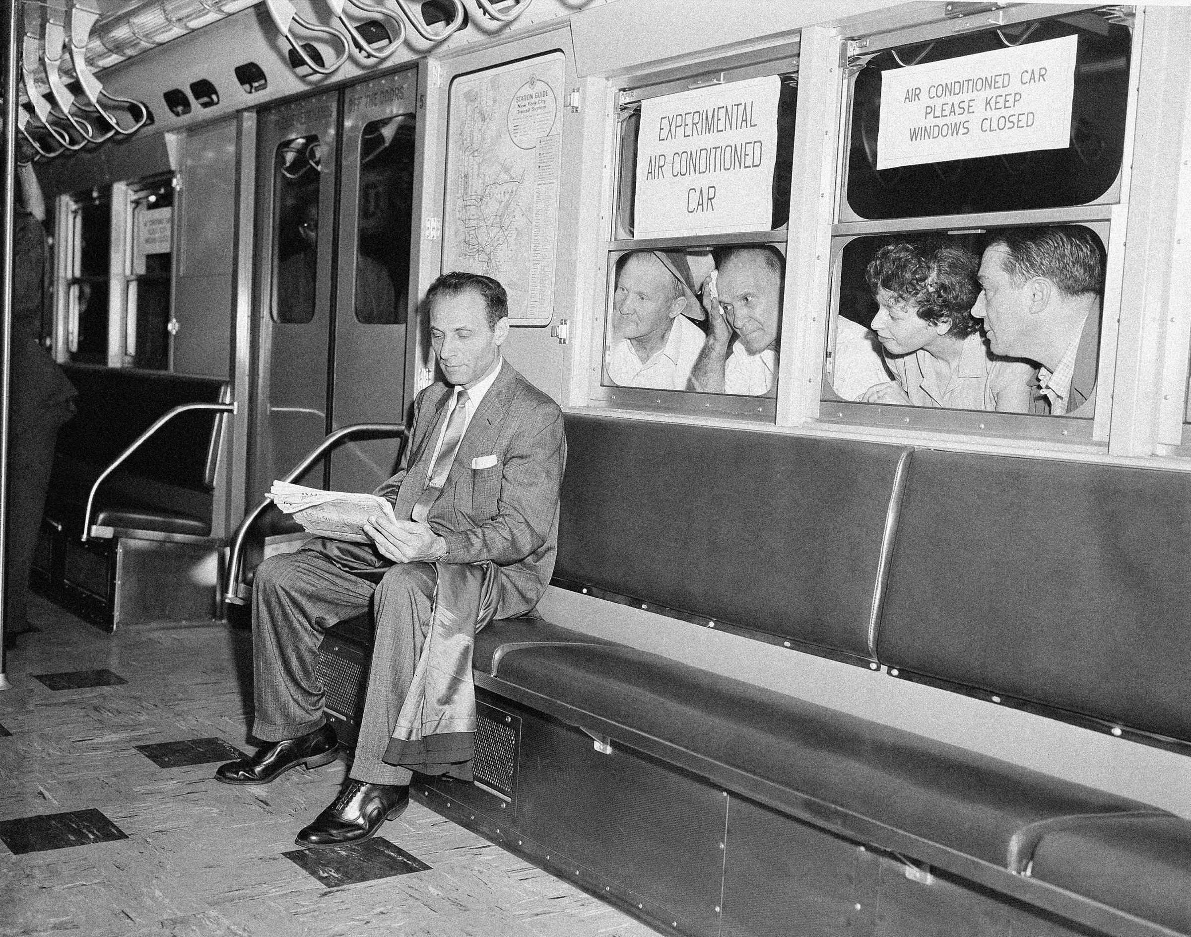 While other subway passengers perspire in the warm and humid underground station, Paul Forman appears cool and comfortable in the experimental air conditioned train, which made its first run in New York City, in July 1956. The test run included six air conditioned cars and two old cars. When the train left Grand Central Station, the temperature was 89 degrees in the old cars, while the new cars registered a temperature of 76.5 degrees.