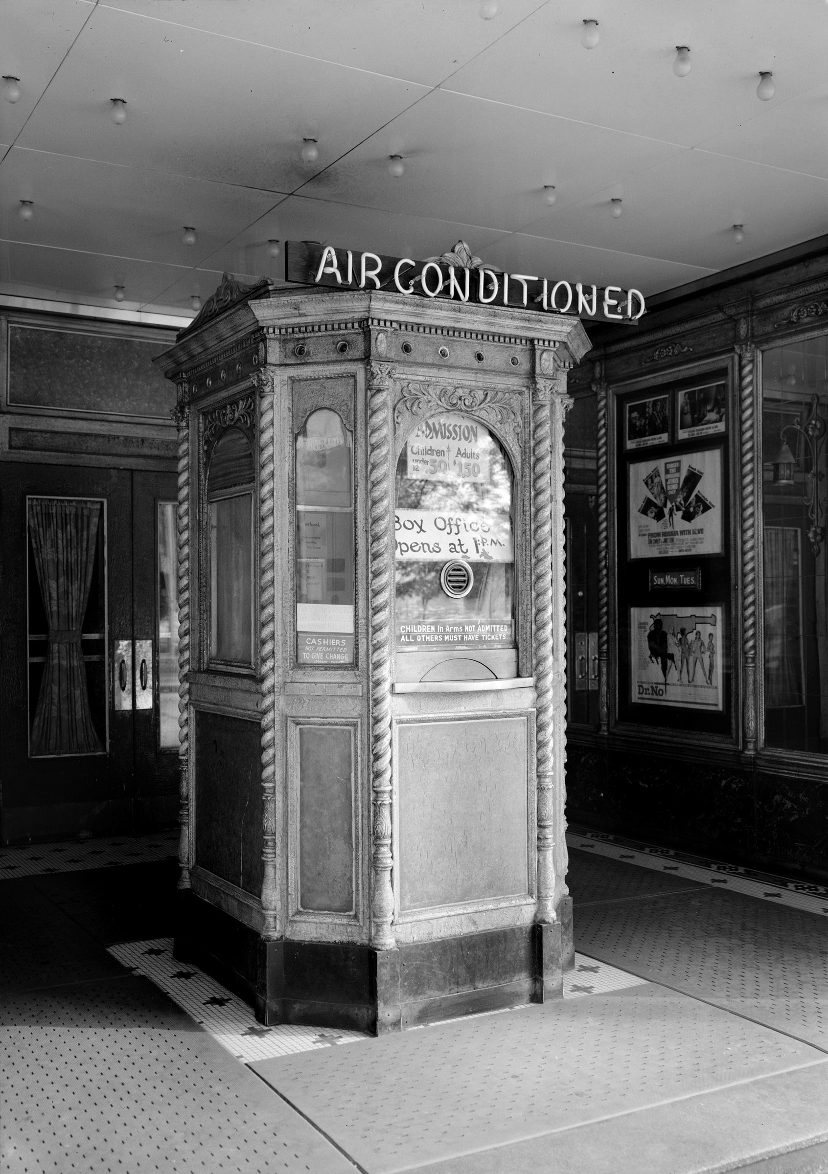 A theater's lobby advertises air conditioning to prospective movie-goers.