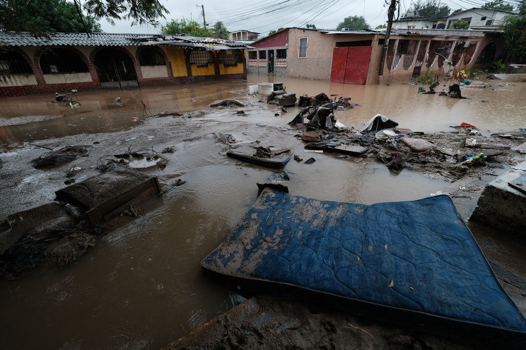 A street covered in mud, debris and the neighbors' belongings that were swept away by Hurricane Iota flooding in San Pedro Sula, Honduras, on Nov. 21, 2020. (Yoseph Amaya—Getty Images)