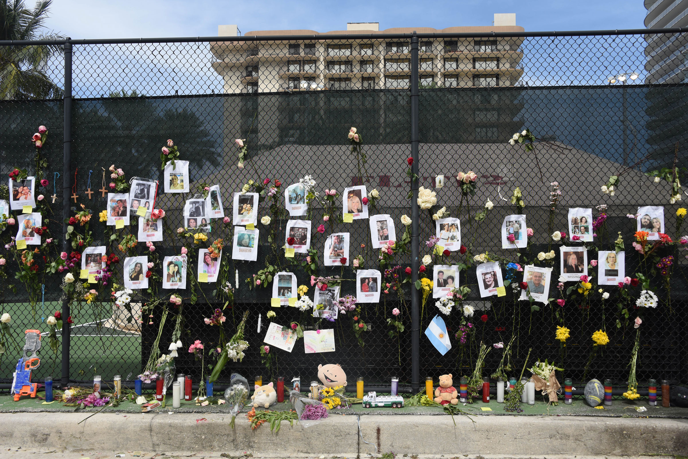 Posters of missing loved ones hang on a fence on a nearby tennis court in Surfside on June 26. (Michele Eve Sandberg—Shutterstock)