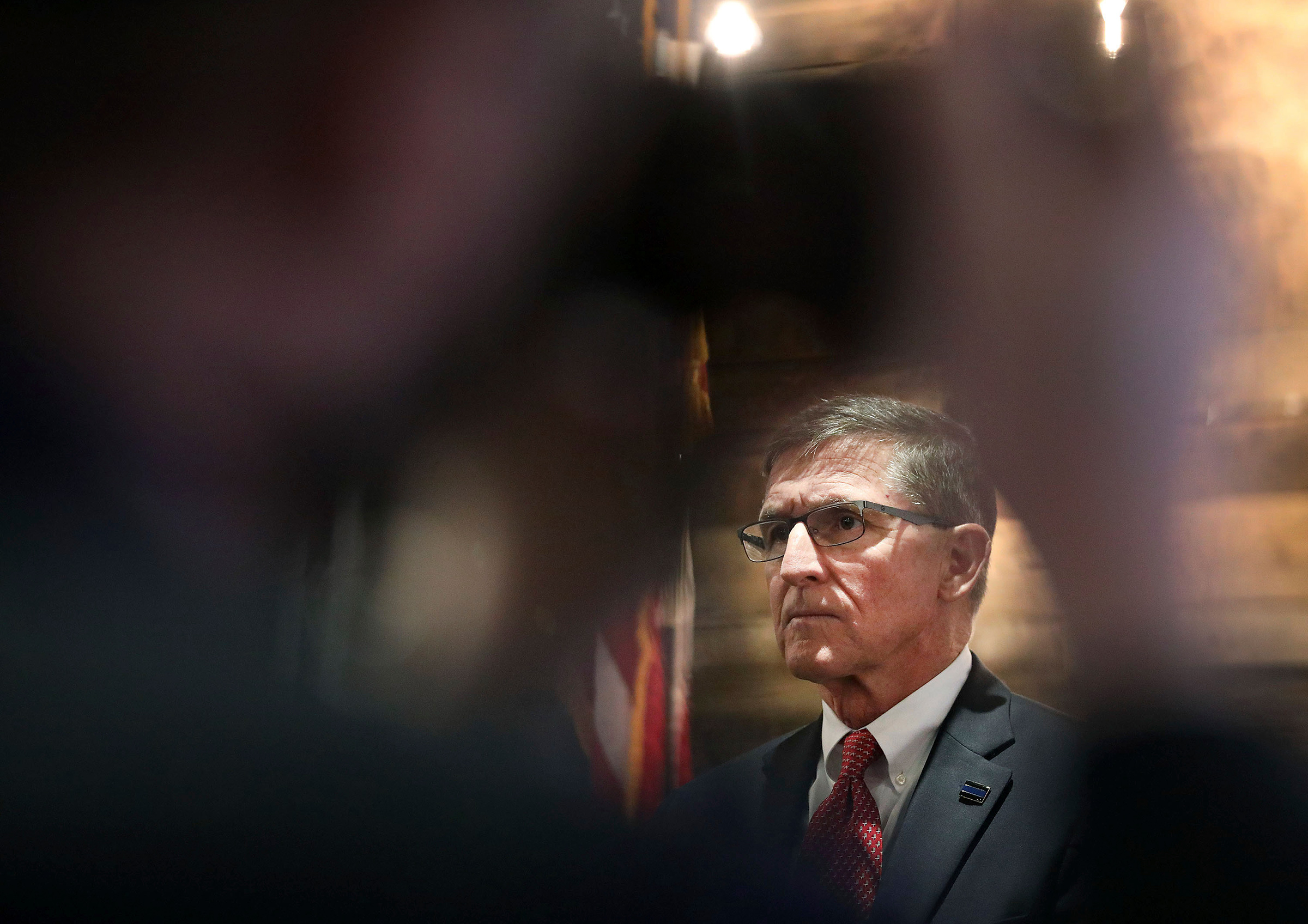 A journalist takes a photo of Retired Gen. Michael Flynn, former National Security Advisor under President Donald Trump, as he takes part in the announcement for Pastor Jackson Lahmeyer's run for the United States Senate, Tuesday, March 16, 2021 in Jenks, Okla. (Mike Simons—Tulsa World/AP)