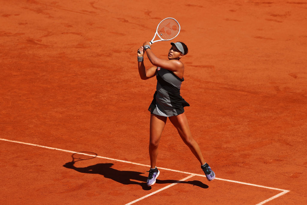 Naomi Osaka of Japan plays a backhand in her First Round match against Patricia Maria Tig of Romania during Day One of the 2021 French Open at Roland Garros on May 30, 2021 in Paris, France. (Julian Finney—Getty Images)