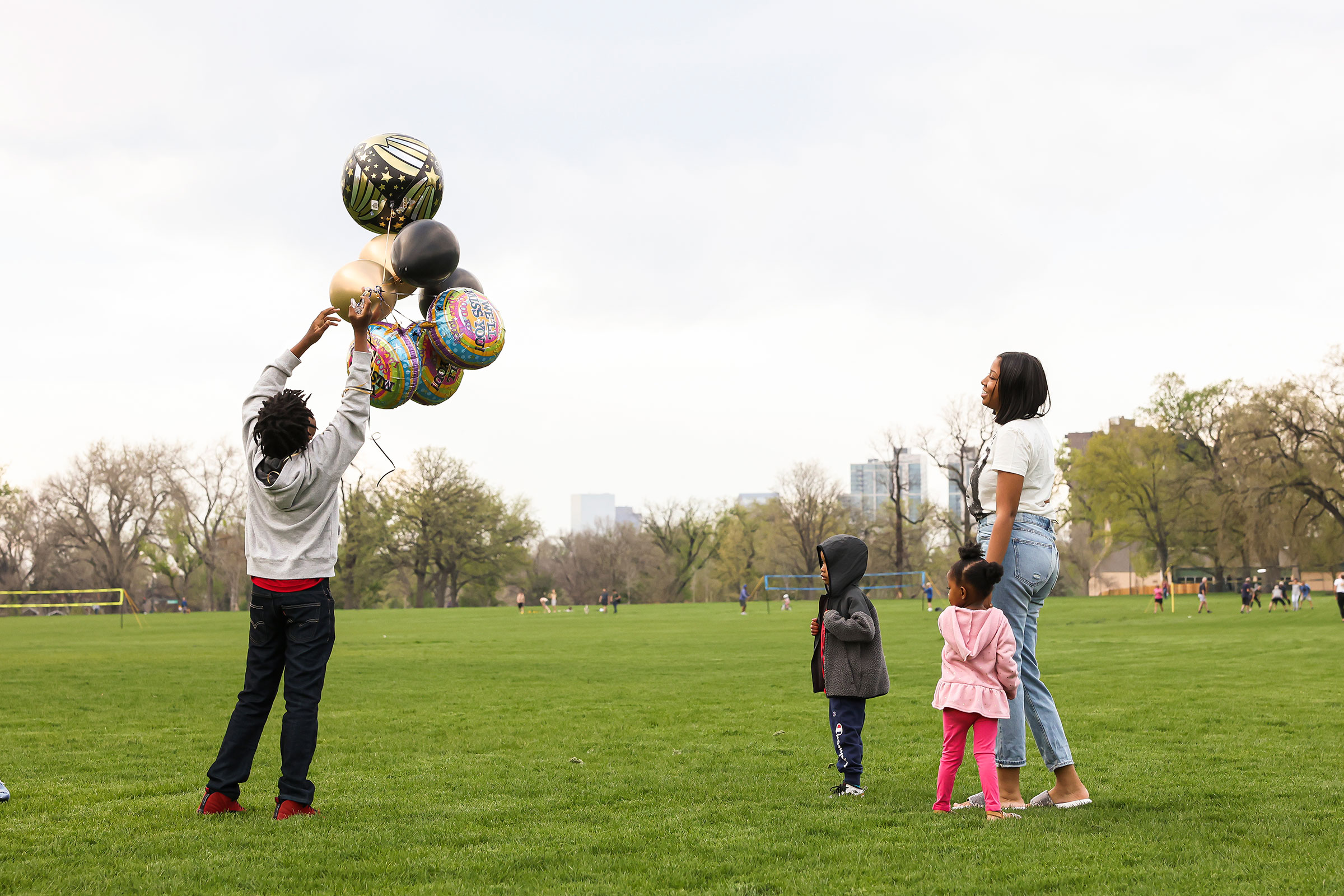 Nehemiah prepares to release balloons in commemoration of his father while his mother Ashley, his 4-year-old bother, Prince, and 3-year-old sister, Zyla, watch nearby (Kevin Mohatt for TIME)