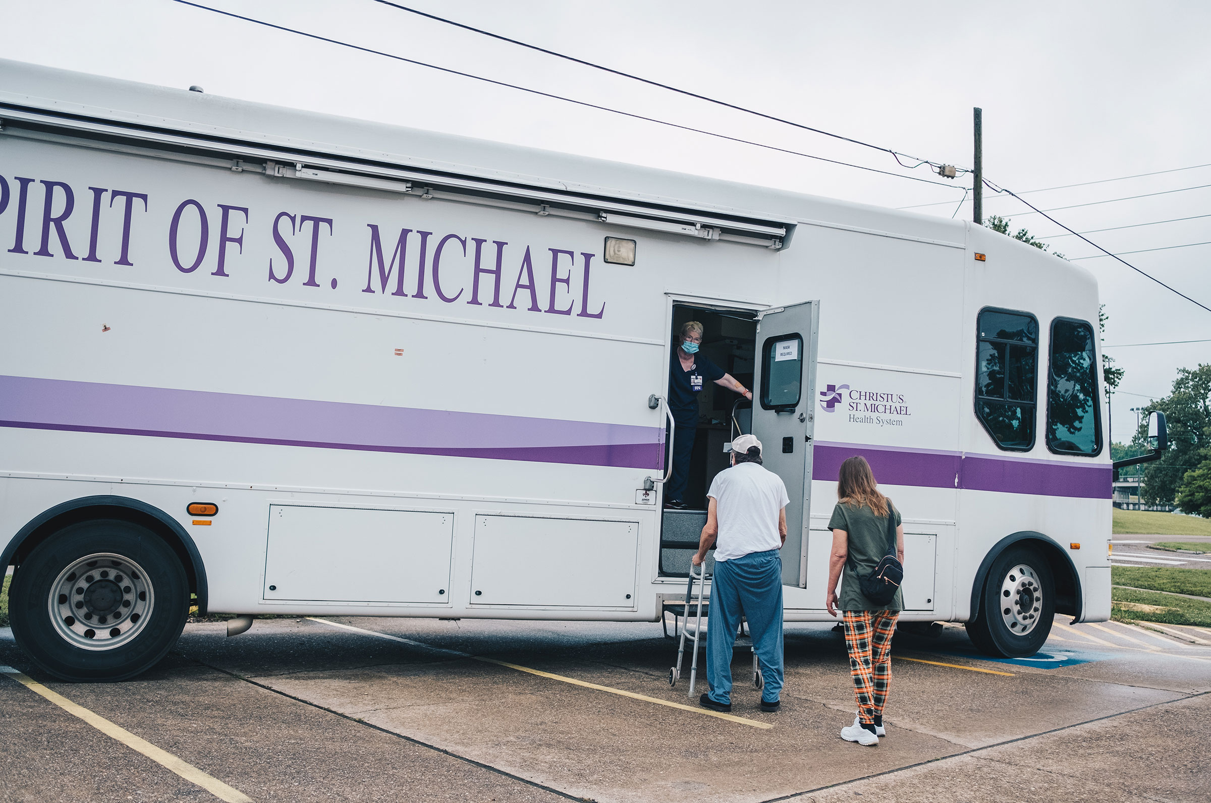 Texarkana, Texas- June 5, 2021.  Patients wait outside the Spirit of St. Michael Mobile Unit to receive the COVID-19 vaccine. CHRISTUS St. Michael has been offering vaccines to Texarkana's underserved and homeless populations. Khadija Farah for TIME.
