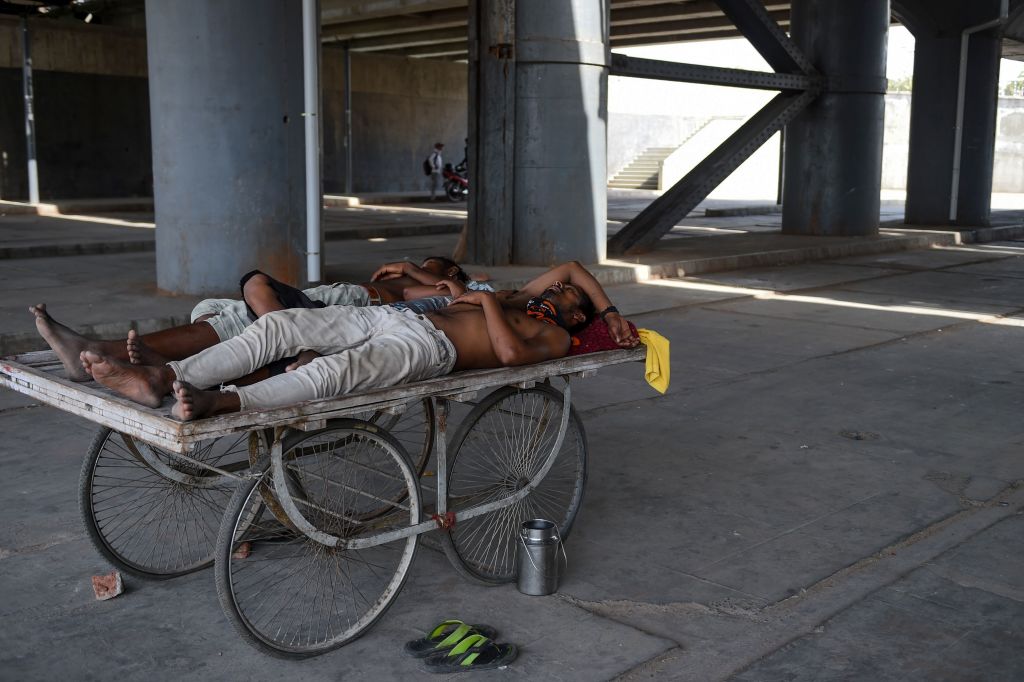 Men rest on a cart under a bridge near Sabarmati river during a hot day in Ahmedabad, India, on May 28, 2019. (Sam Panthaky—Getty Images)
