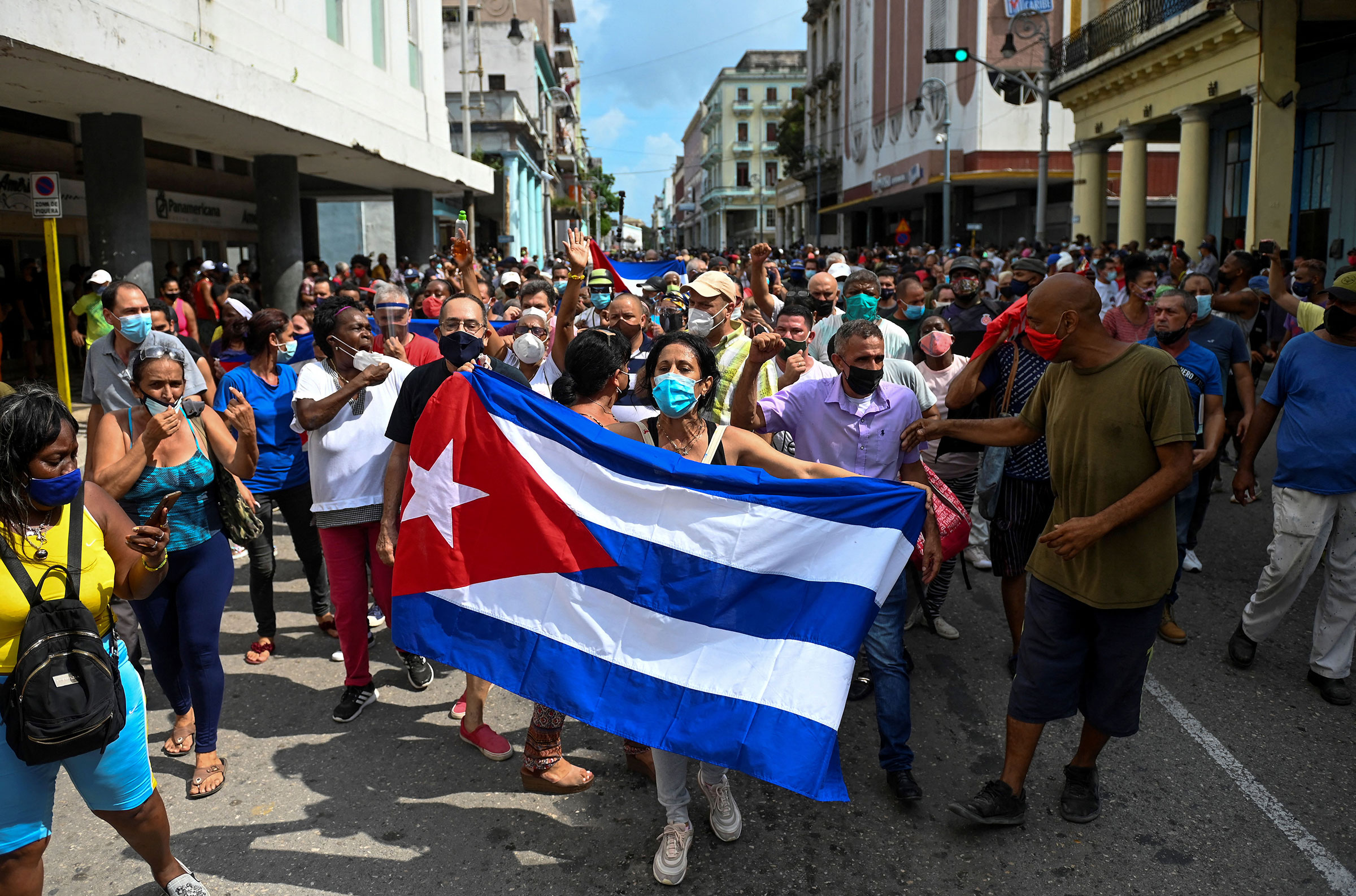 People take part in a demonstration to support the government of the Cuban President Miguel Diaz-Canel in Havana, on July 11, 2021. - Thousands of Cubans took part in rare protests Sunday against the communist government, marching through a town chanting "Down with the dictatorship" and "We want liberty." (Yamil Lage—AFP/Getty Images)