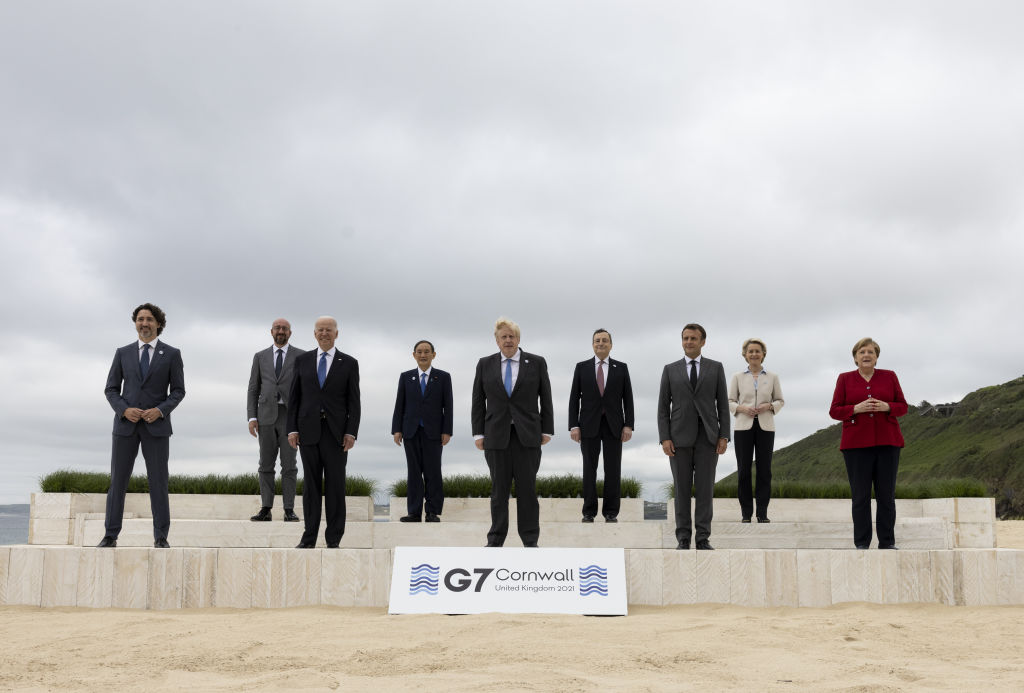 Prime Minister Boris Johnson poses for a photo with Canada's Prime Minister Justin Trudeau, France's President Emmanuel Macron, German Chancellor Angela Merkel, Italy's Prime Minister Mario Draghi, Japan's Prime Minister Yoshihide Suga, European Commission President Ursula von der Leyen and European Council President Charles Michel during the G7 Leaders summit in Cornwall, United Kingdom on June 11, 2021. (Simon Dawson / No 10 Downing Street/Handout/Anadolu Agency via Getty Images))
