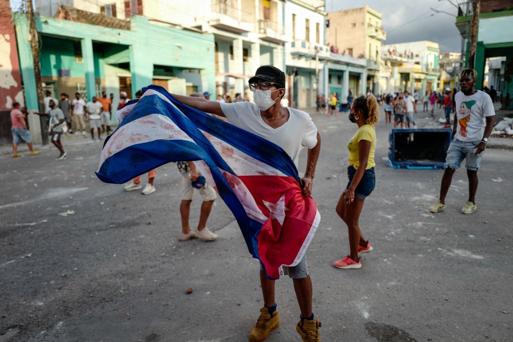 A man waves a Cuban flag during a demonstration against the government of Cuban President Miguel Diaz-Canel in Havana, on July 11, 2021. (Adalberto Roque—AFP/Getty Images)