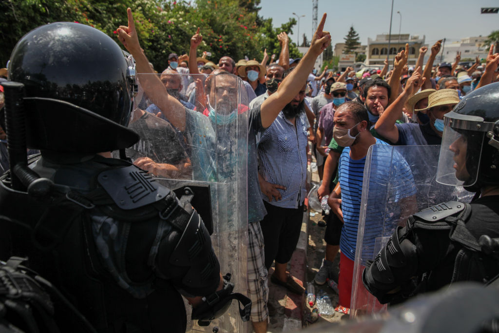 Supporters of the Islamist party Ennahdha in front of the riot police in front of the Tunisian parliament in Bardo, in the capital Tunis, Tunisia, on July 26, 2021 (Chedly Ben Ibrahim—NurPhoto via Getty Images)