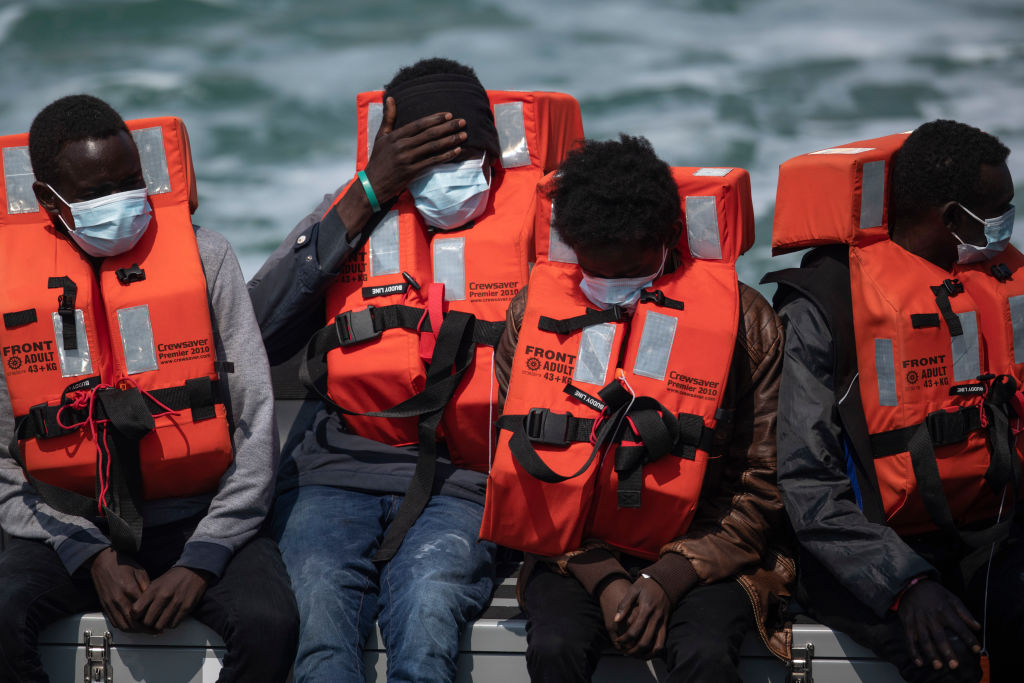 Migrant men arrive at Dover Port after being picked up in the English Channel by the Border Force on July 21, 2021 in Dover, England (Dan Kitwood—Getty Images)