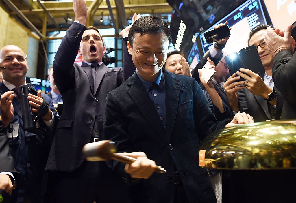 Chinese online retail giant Alibaba founder Jack Ma (C) rings a bell to start the trading of his company's stock on the floor at the New York Stock Exchange in New York on September 19, 2014. (JEWEL SAMAD/AFP via Getty Images)