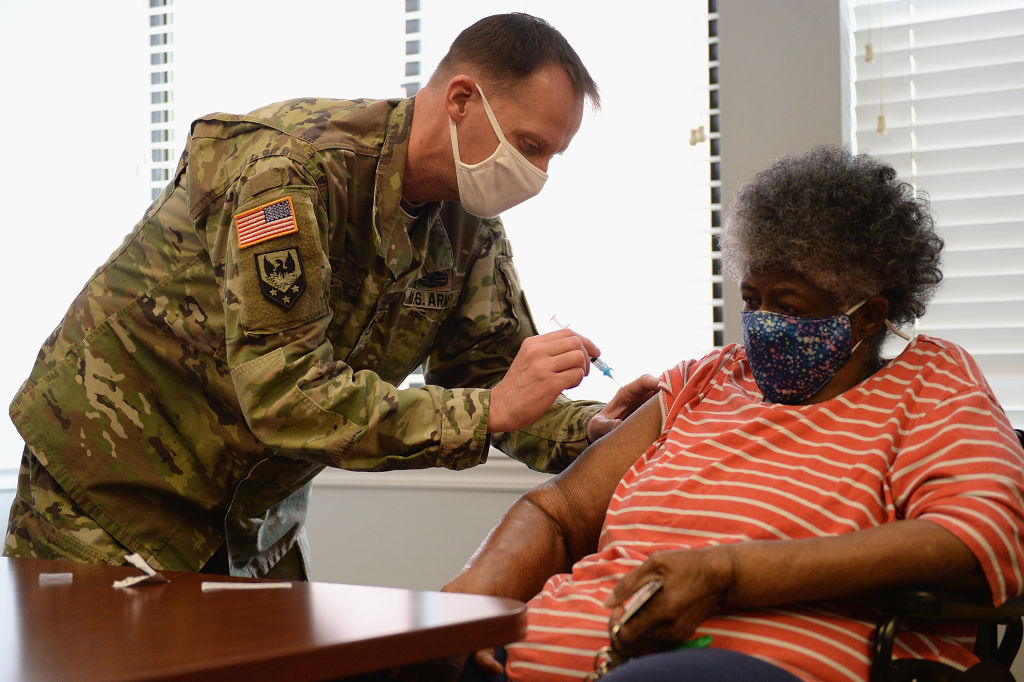 A member of the Missouri Army National Guard administers a Covid-19 vaccine on February 11, 2021 at a senior living facility in St Louis. (Michael Thomas—2021 Getty Images)
