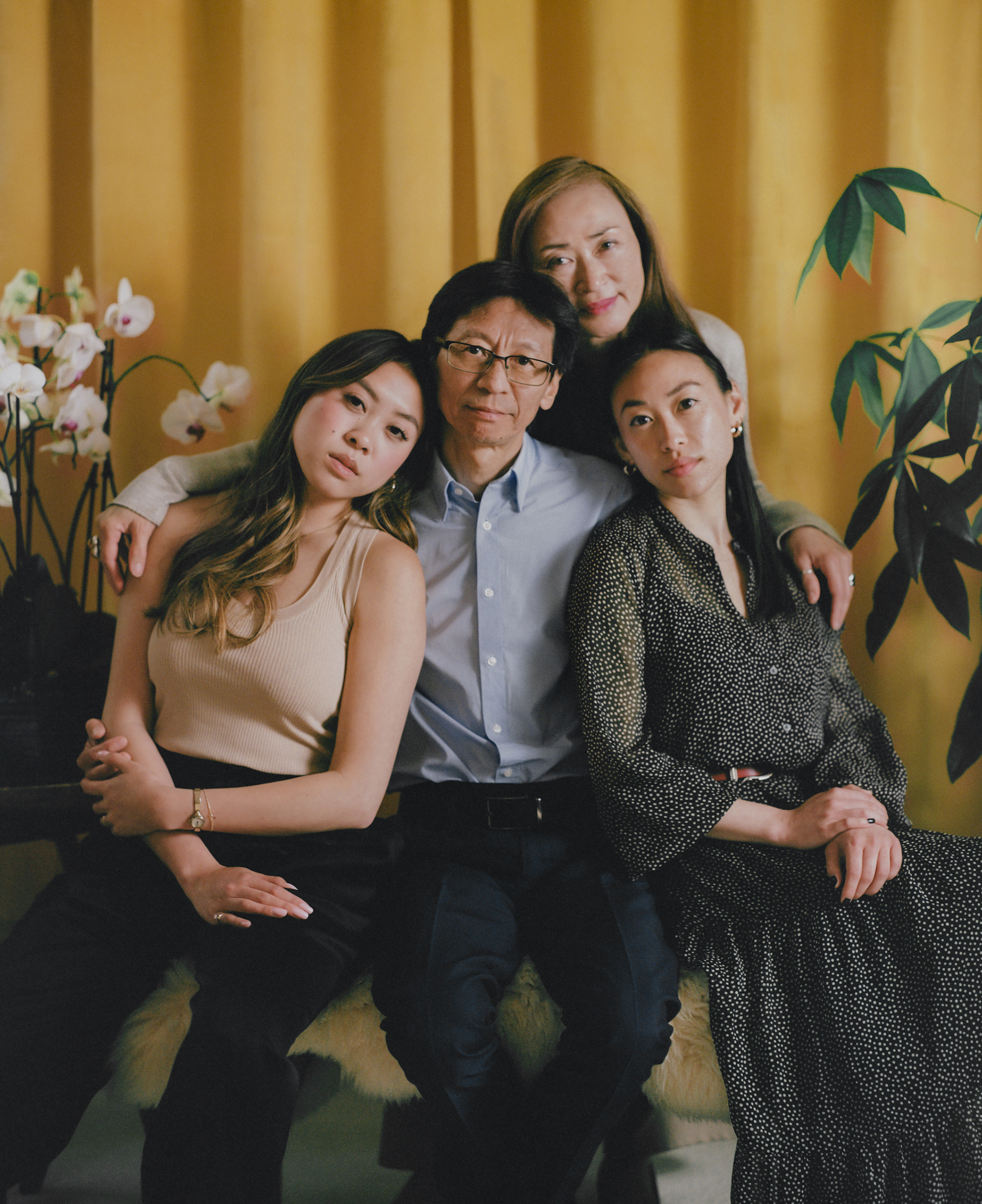 <strong>'HE ISN'T A VICTIM.' </strong>Carl Chan, center, sits with his daughters Crystal Chan, right, and Emerald Chan, left, and his wife Eleanore Tang, above, at home in Alameda, Calif., on May 18. As president of the Oakland Chinatown Chamber of Commerce, Carl, 62, has long made the protection of local elders a priority in his work. When attacks against Asian Americans started increasing in 2020, he ramped up his efforts, handing out whistles and air horns to anyone on the street who would take them. “We respect the elderly,” he says. “To me, to us, to our community, it is the worst when they are attacking our seniors.” Carl’s daughters worried about their father’s safety as he spent his time in areas where incidents of violence had taken place. “What he’s doing is so important,” Crystal, 28, remembers thinking. “While there is a risk, we just can’t keep thinking about that.” On April 29, when Carl was on his way to visit an older Asian man who had been assaulted on a bus, he also fell victim to an unprovoked attack. He remembers hearing a man screaming and yelling a racial slur. Then he describes “a quick punch to my head.” Crystal said the emotions overwhelmed her quickly; first shock, then anger and sadness. She and her sister, who live across the country in New York, flew home as soon as they could. “It’s not easy for our family, especially [when] the ones close to you become the victim,” Eleanore says. “It’s so hard. It’s so hard.” But Carl, scraped and bruised, emerged from the attack even more determined. On May 15, he walked side by side with his daughters and wife in a “Unity Against Hate” rally that he helped organize. “While he was physically assaulted, he isn’t a victim,” says Emerald, 24. “He’s showing that he’s strong.” (Emanuel Hahn for TIME)
