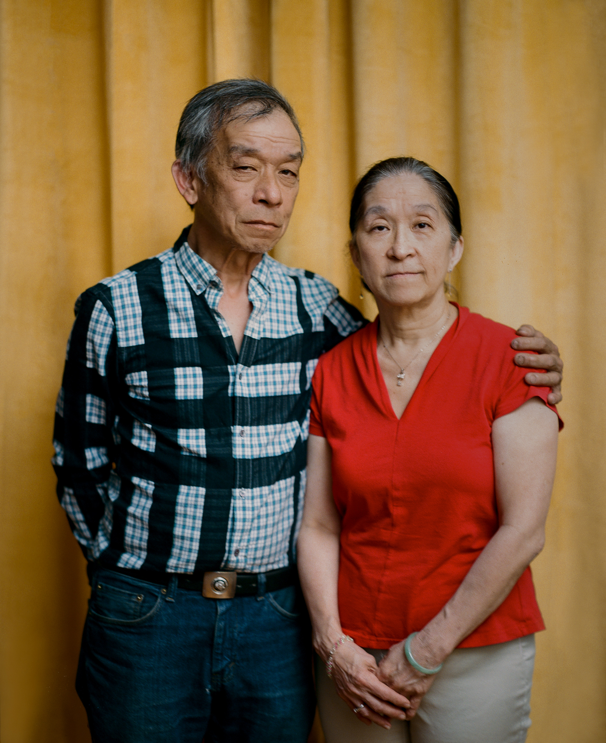 <strong>'I'M PROUD OF WHAT HE DID.' </strong>Tommy Lau, 63, stands beside his older sister Maggie Wong inside his Brooklyn home on May 22. On March 23, Lau rushed to protect an elderly Asian couple who were being robbed of their groceries—a choice that Wong says reflects her brother’s typical boldness. But when Lau intervened, the man spat on his face, punched him on the side of his head and called him a racial slur. Lau has not been able to return to work as a New York City bus driver, because of neck and shoulder injuries he sustained during the attack. Wong, 66, says it’s been difficult to watch her brother continue to struggle months later. “I feel bad,” she says, adding that she supports Lau, emotionally and financially, whenever he needs it. “I’m proud of what he did.” Meanwhile, despite all that he’s endured, Lau doesn’t regret getting involved that day. Since immigrating to the U.S. from Hong Kong at age 3, he has long faced racism—his elementary-school classmates bullied him so often about his birth name, Kok Wah Lau, that his teacher changed it to Tommy—and he has had enough. “The lowest low of people does that, attacking the elderly,” he says. “I just couldn’t take it anymore.” (Emanuel Hahn for TIME)