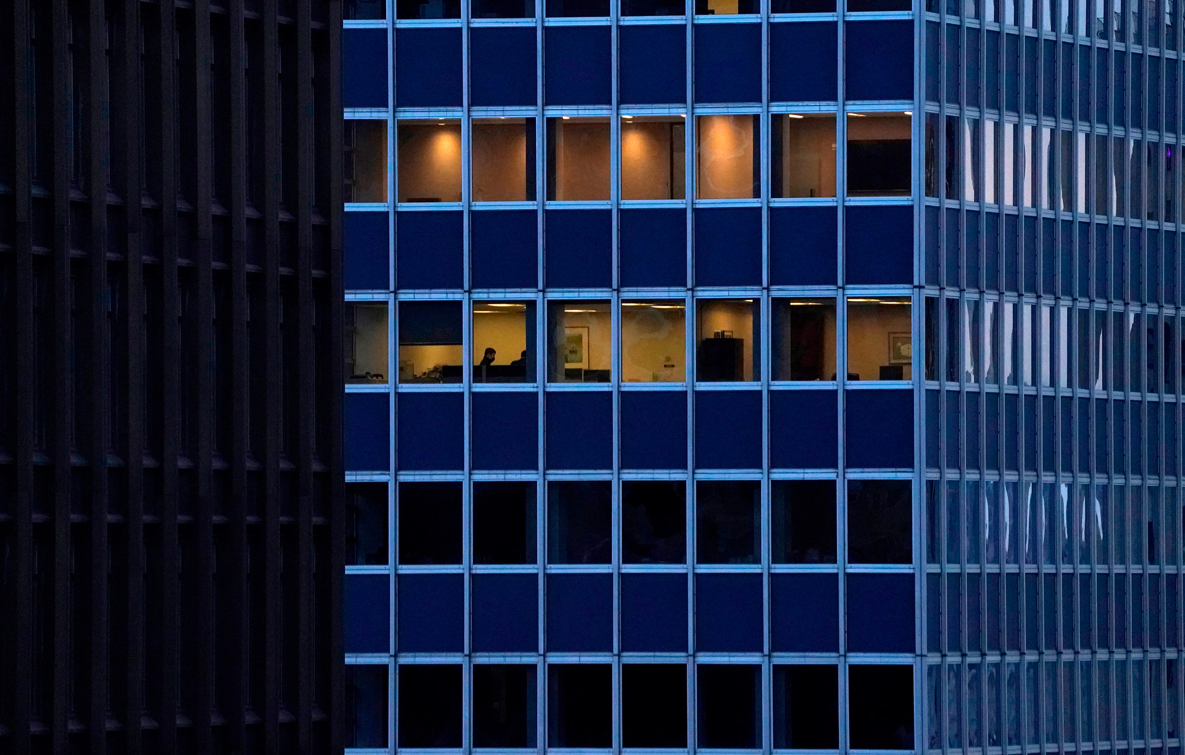 Employees work in an office building in Midtown, New York City, on Jan. 26.