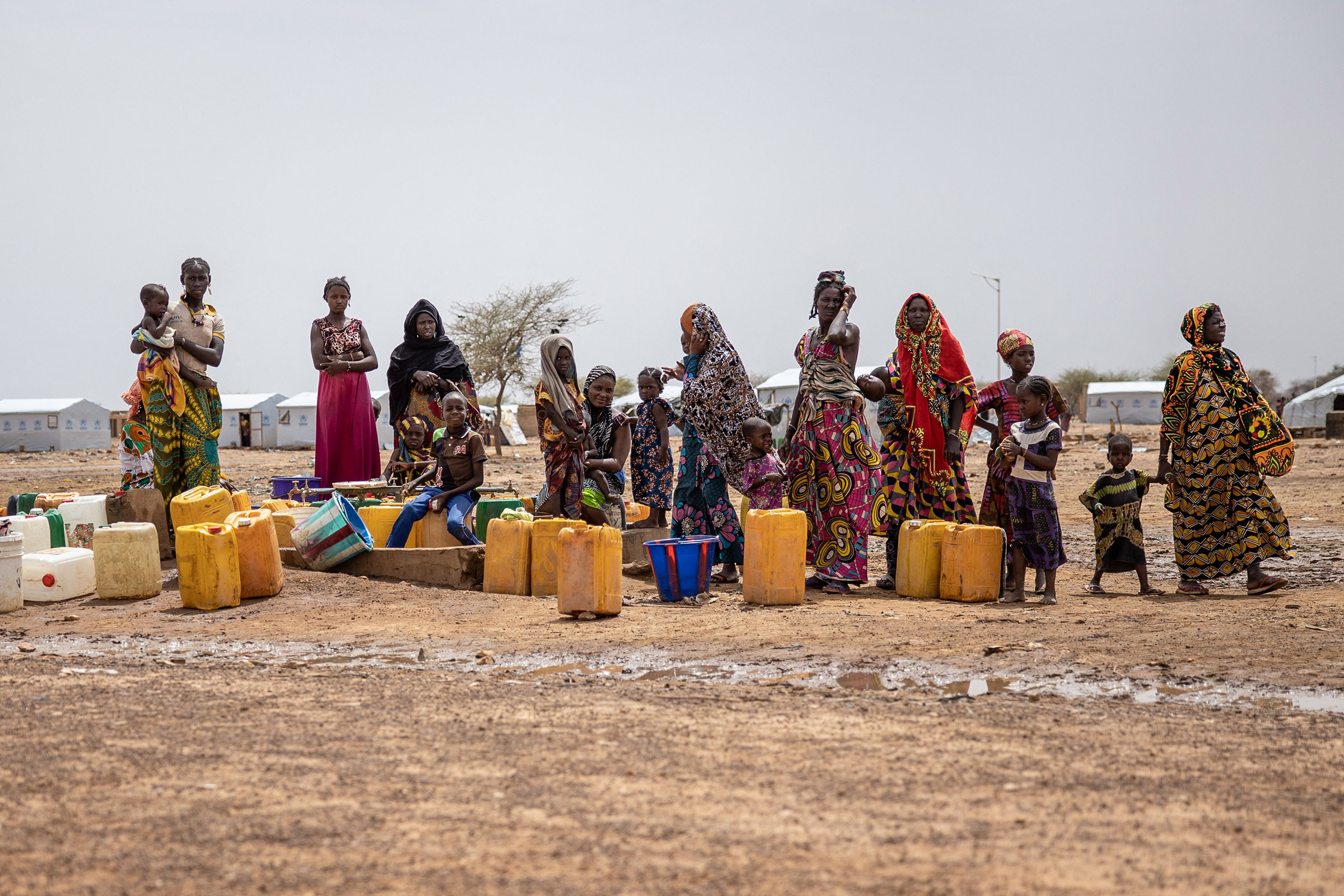 Women line up for water at Goudoubo camp in Burkina Faso, on June 20. The camp is sheltering thousands of Malians who have fled jihadist violence in the region. (Olympia de Maismont—AFP/Getty Images)
