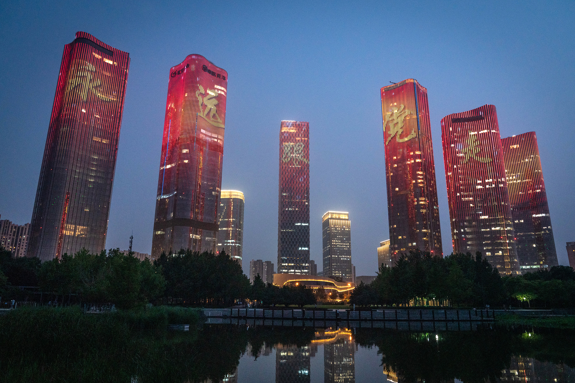 Chinese characters reading "Always follow the party" illuminate buildings during a light show marking the upcoming centenary of the Community Party in Beijing on June 26. (Yan Cong—Bloomberg/Getty Images)