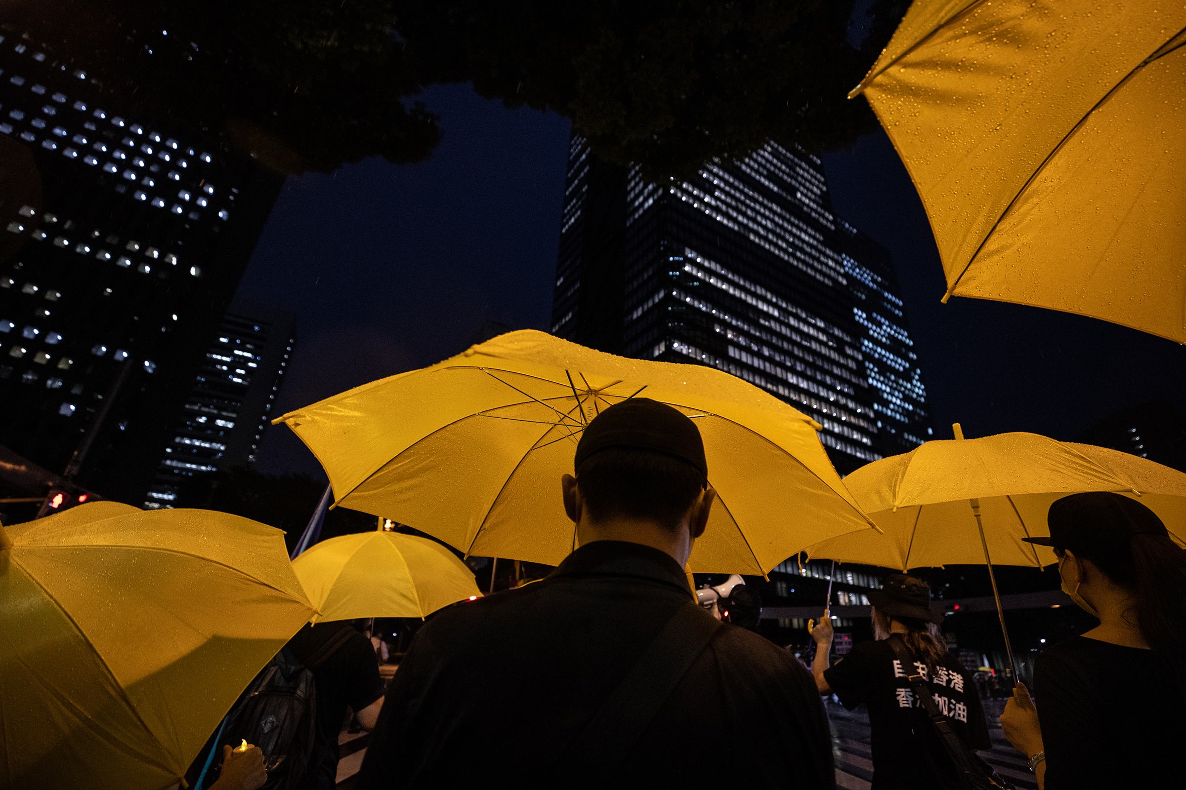 Protesters march through the Shinjuku area of Tokyo during a protest against the Chinese Communist Party on July 1, the 100th anniversary of its founding. (Takashi Aoyama—Getty Images)