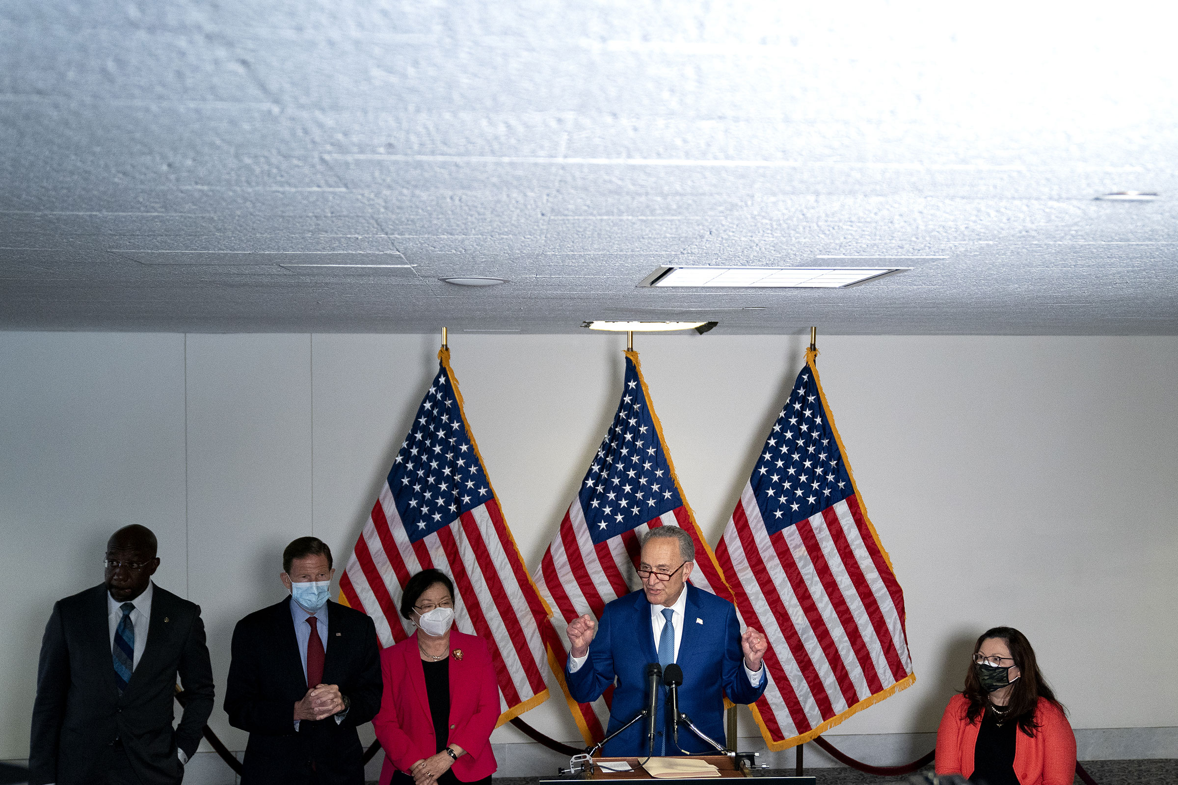 Senate Majority Leader Chuck Schumer, a Democrat from New York, center, speaks to members of the media following Senate Democratic policy luncheons in the Hart Senate Office Building in Washington, on April 20, 2021. (Stefani Reynolds—Bloomberg/Getty Images)