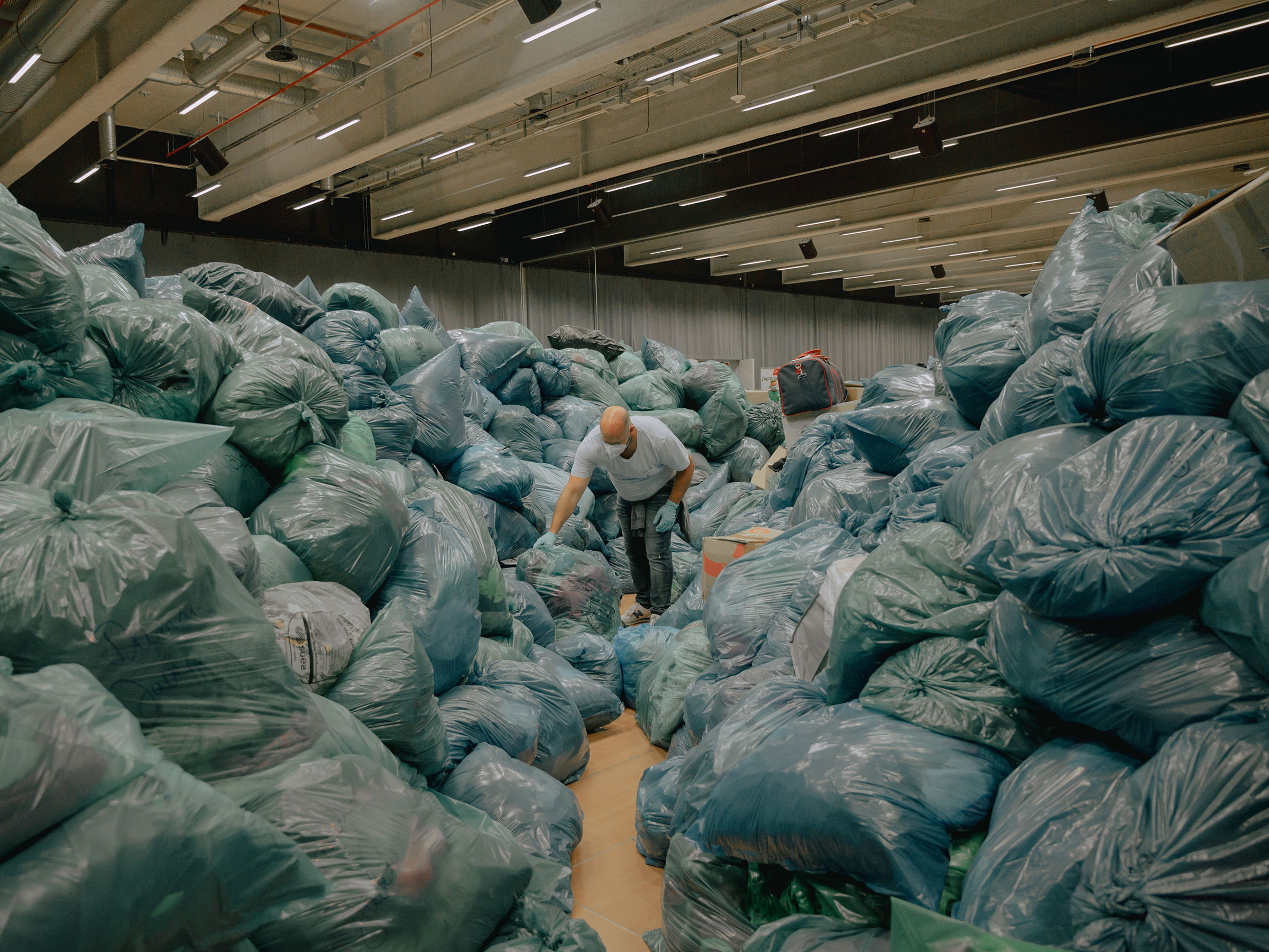 Hundreds of people have volunteered to sort through donations for flood victims at a collection point in Nürburgring, Germany, on July 16. (DOCKS Collective)