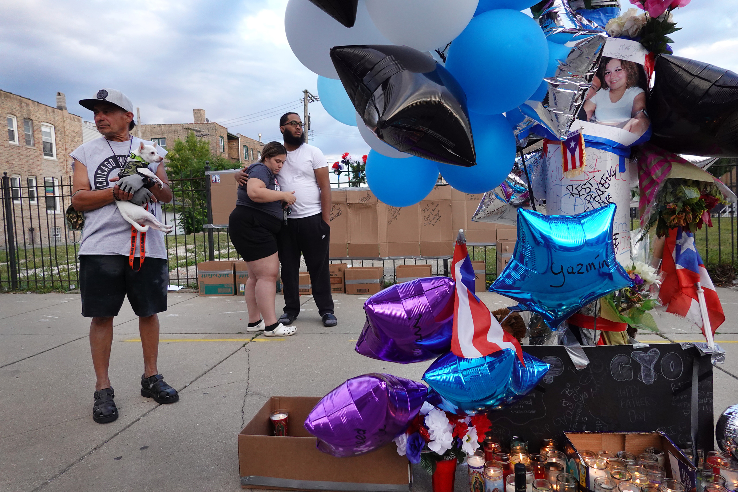 Mourners gather to remember Gyovanni Arzuaga, 24, and Yasmin Perez, 25, at a makeshift memorial at the location where both were shot as they celebrated their Puerto Rican heritage Saturday in the Humboldt Park neighborhood on June 22 in Chicago.