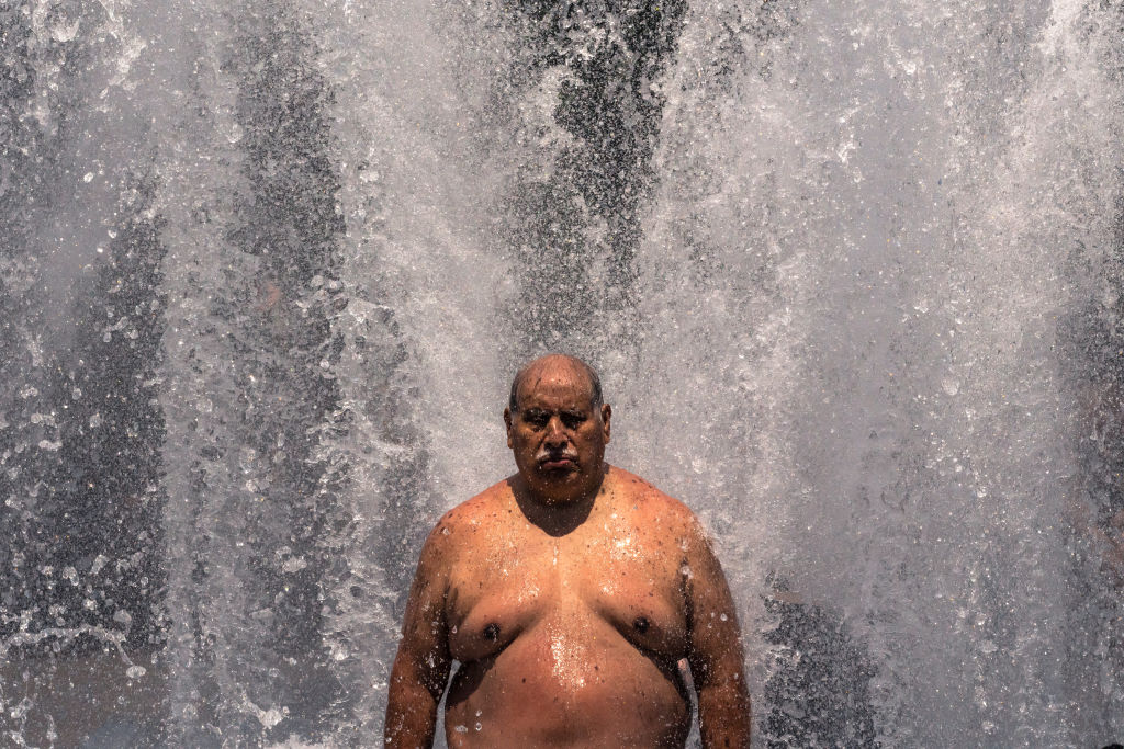 Pablo Miranda cools off in the Salmon Springs Fountain on June 27, 2021 in Portland, Oregon.