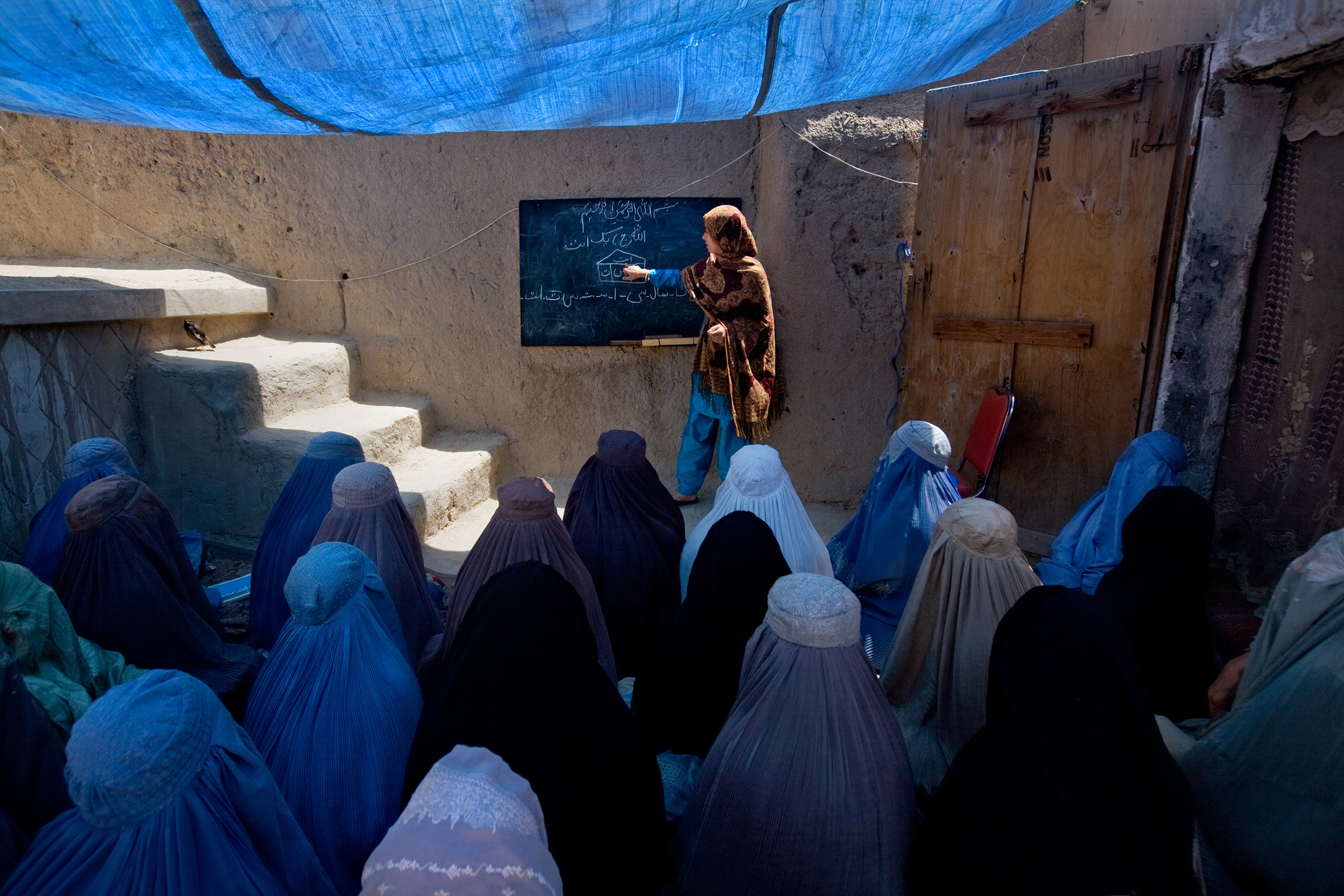 Marzia teaches first grade at a private residence in Kandahar on April 20, 2009. Security concerns prompt the girls to wear burqas when outsiders visit, but Marzia refused to wear hers. Deteriorating security and a shortage of schools for girls have prompted discreet classrooms to spring up in area homes.