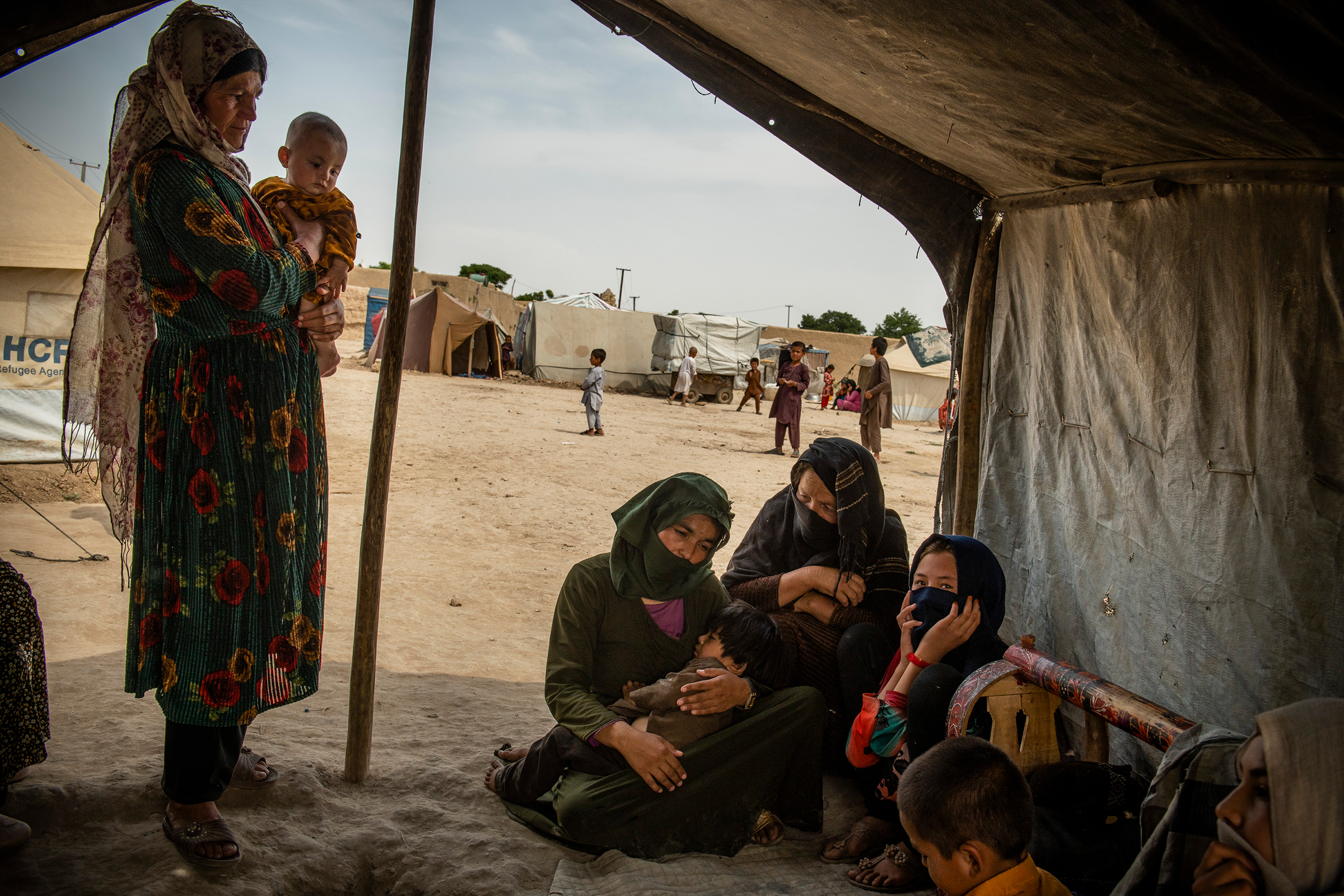 Kowsar 13, and her sister, Madina, 15, in a tent for internally displaced people in Afghanistan's northern Jowzjan Province on May 3, 2021. They have not been able to continue their education because the Taliban took over their home and banned girls like her from going to school.