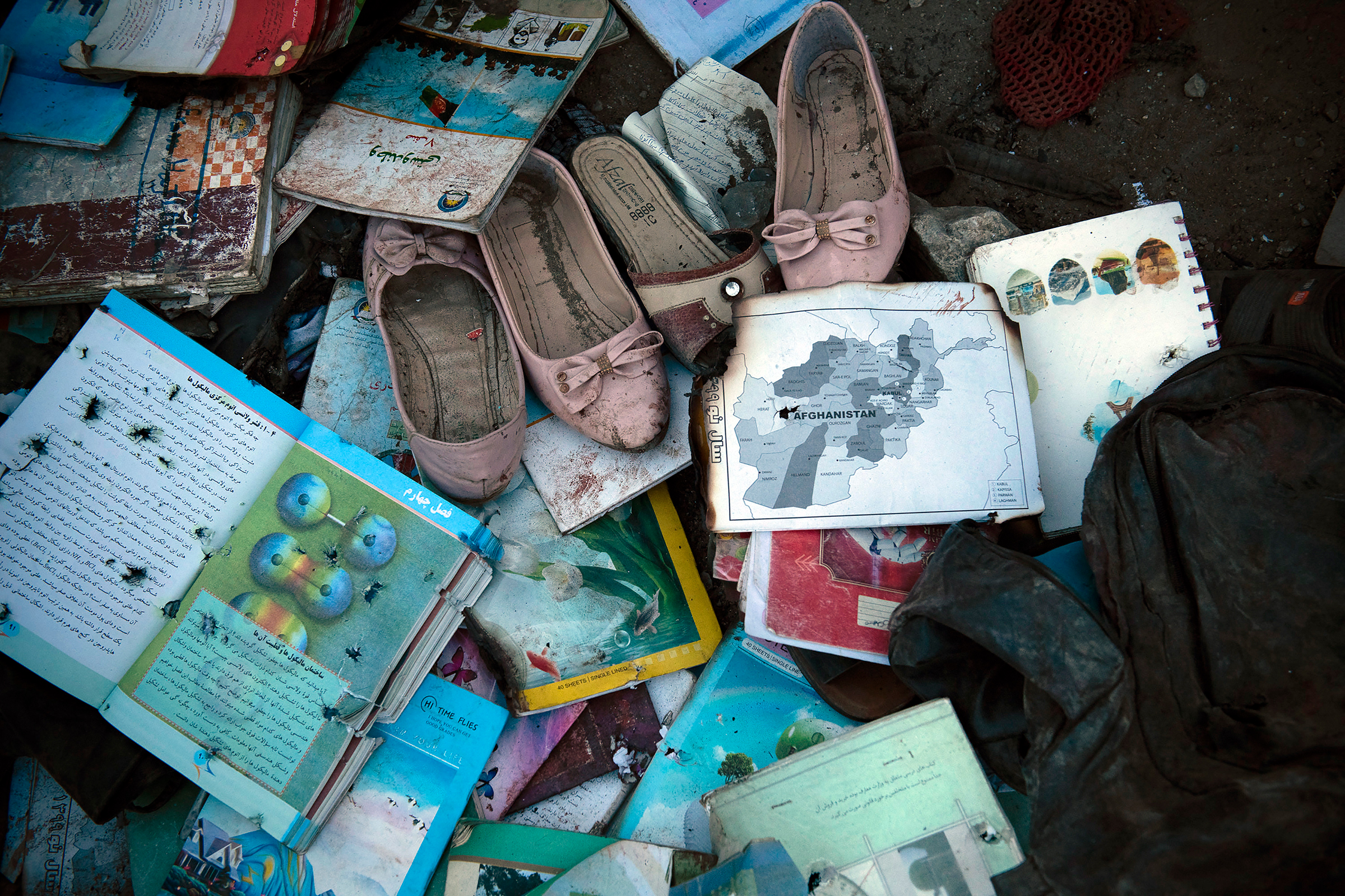 Items recovered outside Sayed Ul-Shuhada high school in Kabul are laid out on May 8, 2021, so families can identify and collect them after a bombing occurred that afternoon.