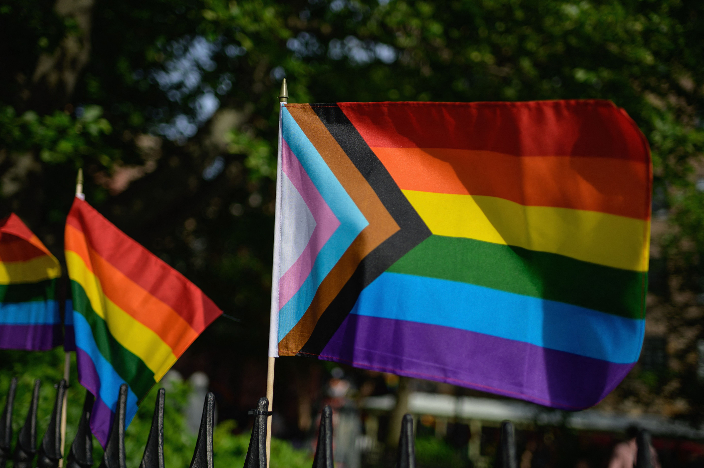 A Progress Pride flag alongside rainbow flags are seen at the Stonewall National Monument, the first US national monument dedicated to LGBTQ history and rights, on June 1, 2020 in New York City. (Angela Weiss—AFP/Getty Images)