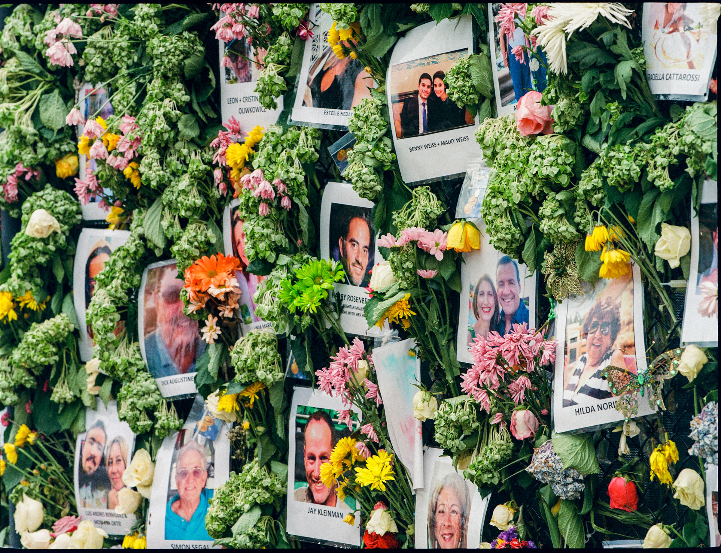 A memorial wall, set up on a nearby tennis court fence, full of posters of missing victims on June 30. (Ysa Pérez for TIME)