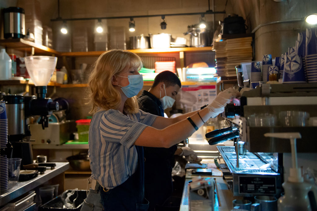 A barista wearing a mask prepares coffee on August 23, 2020, during New York's Phase 4 of re-opening following restrictions imposed to slow the spread of coronavirus (Alexi Rosenfeld—Getty Images)