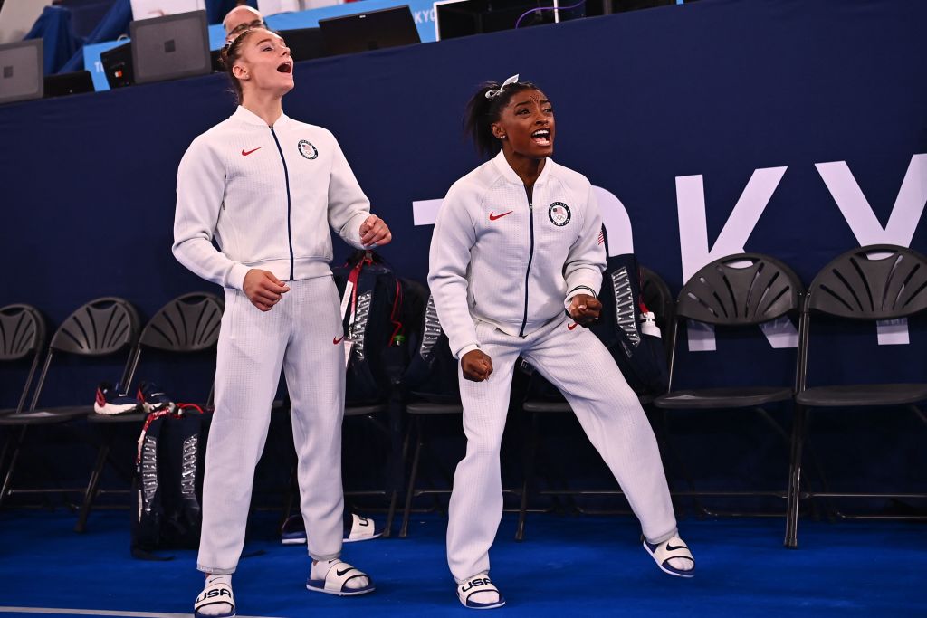 Team USA's Grace Mc Callum and USA's Simone Biles react during the artistic gymnastics women's team final during the Tokyo 2020 Olympic Games at the Ariake Gymnastics Centre in Tokyo on July 27, 2021. (Loic Venance—AFP via Getty Images)