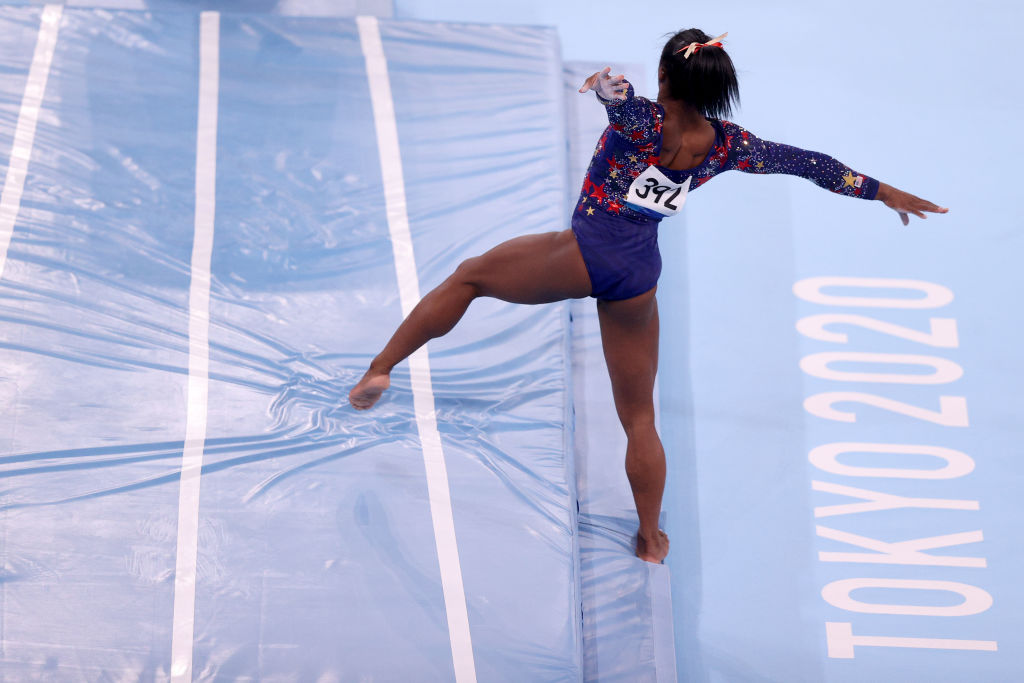 Simone Biles of Team USA falls out of bounds during a vault during Women's Qualification on day two of the Tokyo 2020 Olympic Games at Ariake Gymnastics Centre on July 25, 2021 in Tokyo, Japan. (Ezra Shaw—Getty Images)