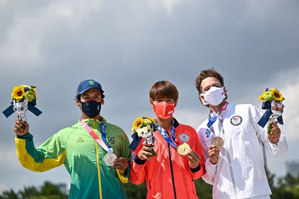 Gold medallist Japan's Yuto Horigome (C), silver medallist Brazil's Kelvin Hoefler (L) and bronze medallist Jagger Eaton of the US pose on the podium at the end of the men's street prelims during the Tokyo 2020 Olympic Games at Ariake Sports Park Skateboarding in Tokyo on July 25, 2021. (Jeff Pachoud–AFP/Getty Images)