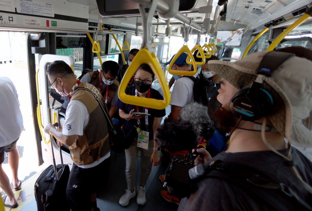 Media members ride the bus from the Main Press Center at Tokyo Big Sight to the transport hub ahead of the Tokyo 2020 Olympic Games on July 22, 2021 in Tokyo, Japan. (Elsa—Getty Images)
