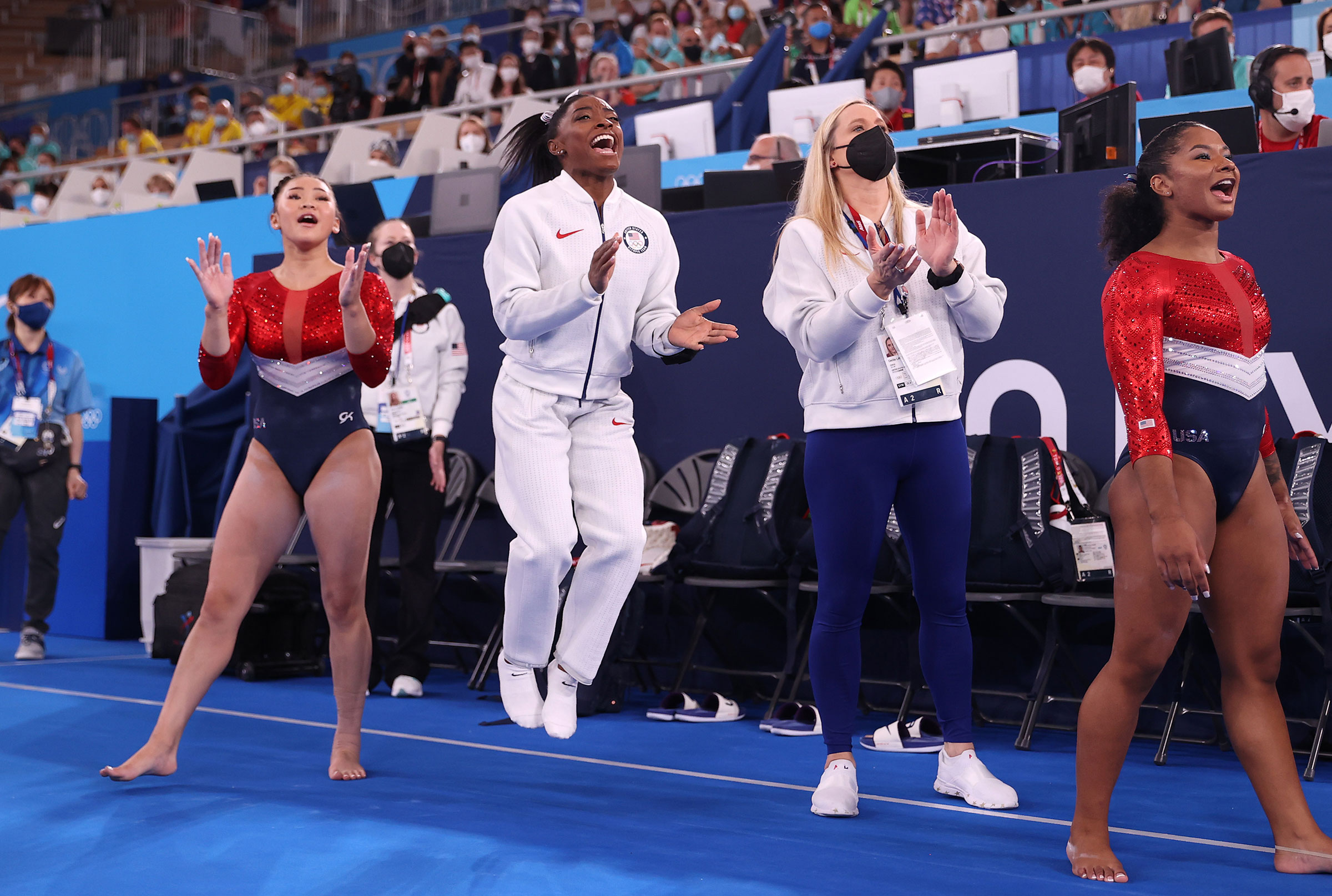 Sunisa Lee, Simone Biles, coach Cecile Landi and Jordan Chiles of Team United States cheer as Grace McCallum competes in floor routine during the Women's Team Final on July 27. (Laurence Griffiths—Getty Images)