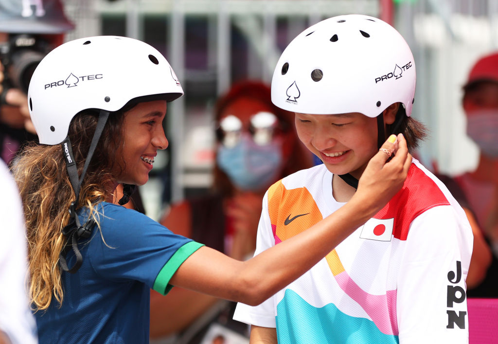 Rayssa Leal puts her hand up to the face of Momiji Nishiya during the Women's Street Final at the Tokyo 2020 Olympic Games on July 26. (Patrick Smith—Getty Images)