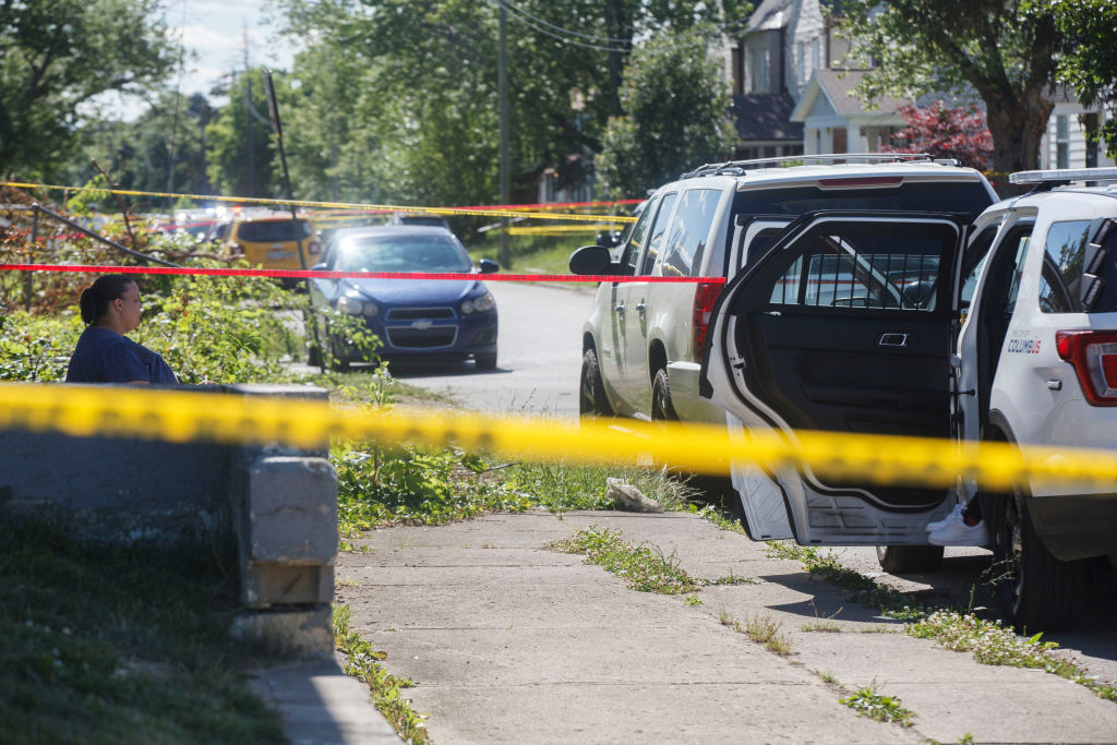 A woman sits at the scene of a police- involved shooting in Columbus, Ohio on June 22. (Stephen Zenner—Getty Images)