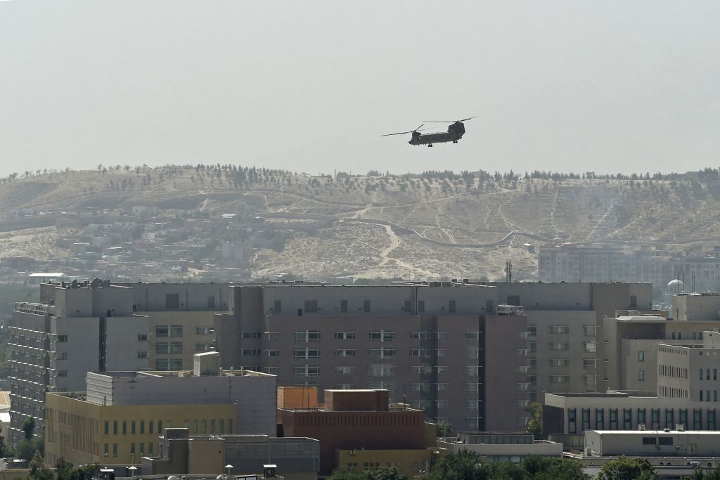A U.S. military helicopter is pictured flying above the U.S. embassy in Kabul on August 15, 2021. (WAKIL KOHSAR/AFP via Getty Images)