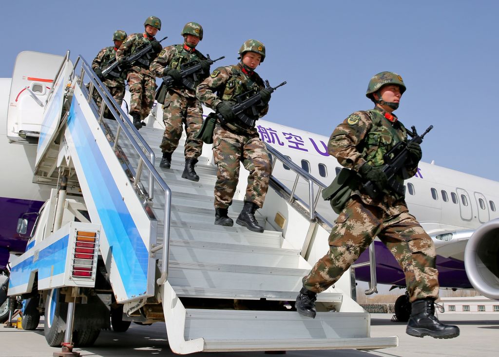 This photo taken on February 27, 2017 shows Chinese military police getting off a plane to attend an anti-terrorist oath-taking rally in Hetian, northwest China's Xinjiang Uighur Autonomous Region. (AFP via Getty Images)