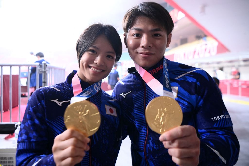 Japan's Hifumi Abe, gold medalist in the men's -66kg judo competition at the Tokyo 2020 Olympic Games, and her sister Uta Abe, gold medalist in the women's judo -52kg competition at the Tokyo 2020 Olympic Games, pose with their medals before the last block of the third day of judo competition during the Tokyo 2020 Olympic Games at the Nippon Budokan in Tokyo on July 26, 2021.