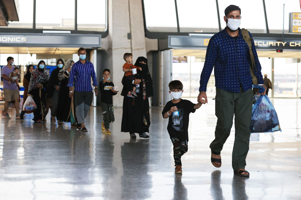 Refugees arrive at Dulles International Airport after being evacuated from Kabul following the Taliban takeover of Afghanistan August 27, 2021 in Dulles, Virginia. (Chip Somodevilla—Getty Images))