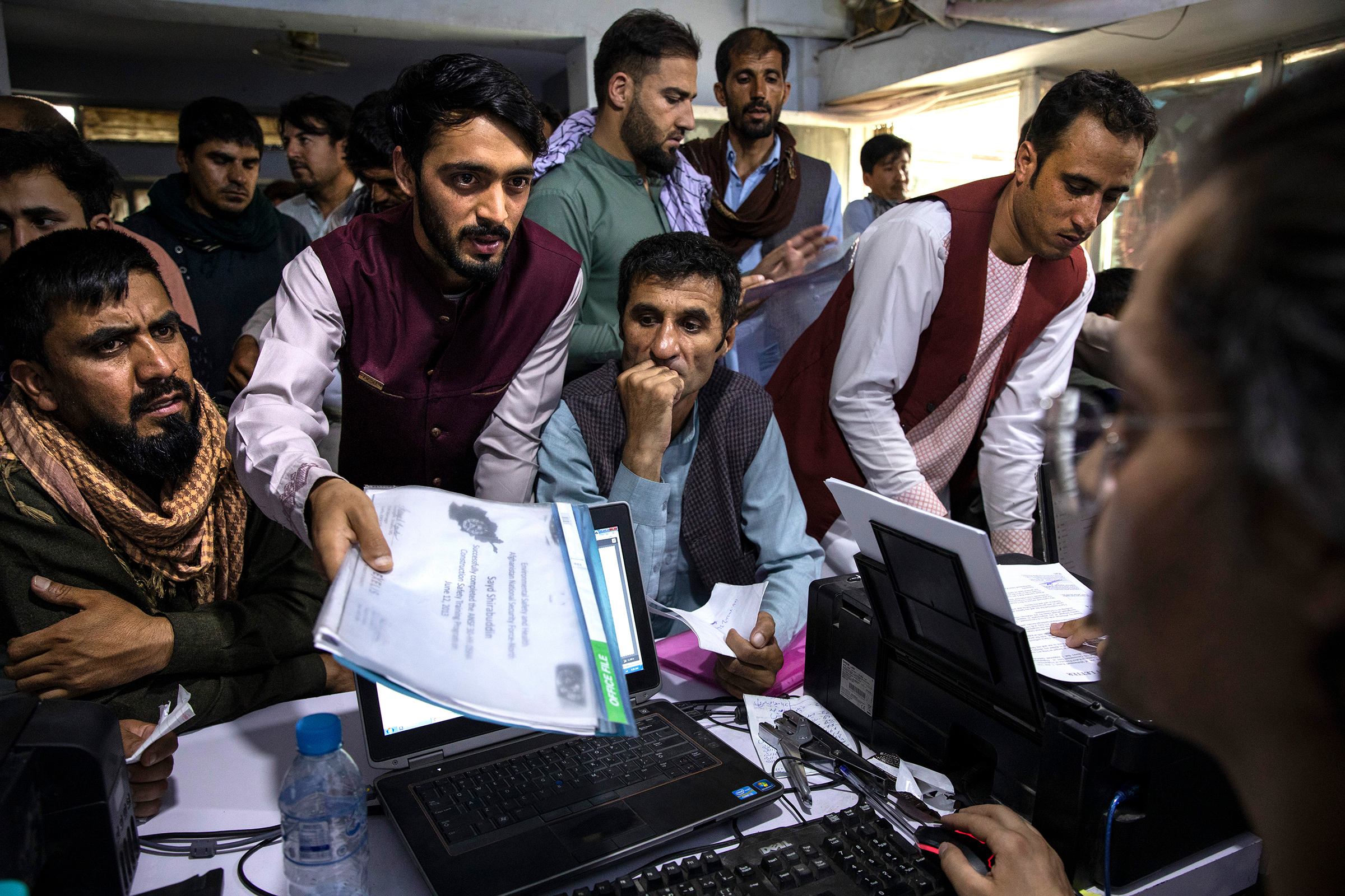 Men crowd into an Internet café while seeking help with applications for the Special Immigrant Visa program in Kabul on Aug. 8. (Paula Bronstein—Getty Images)
